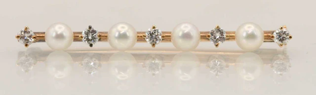 A 14ct yellow gold pearl and diamond set bar brooch