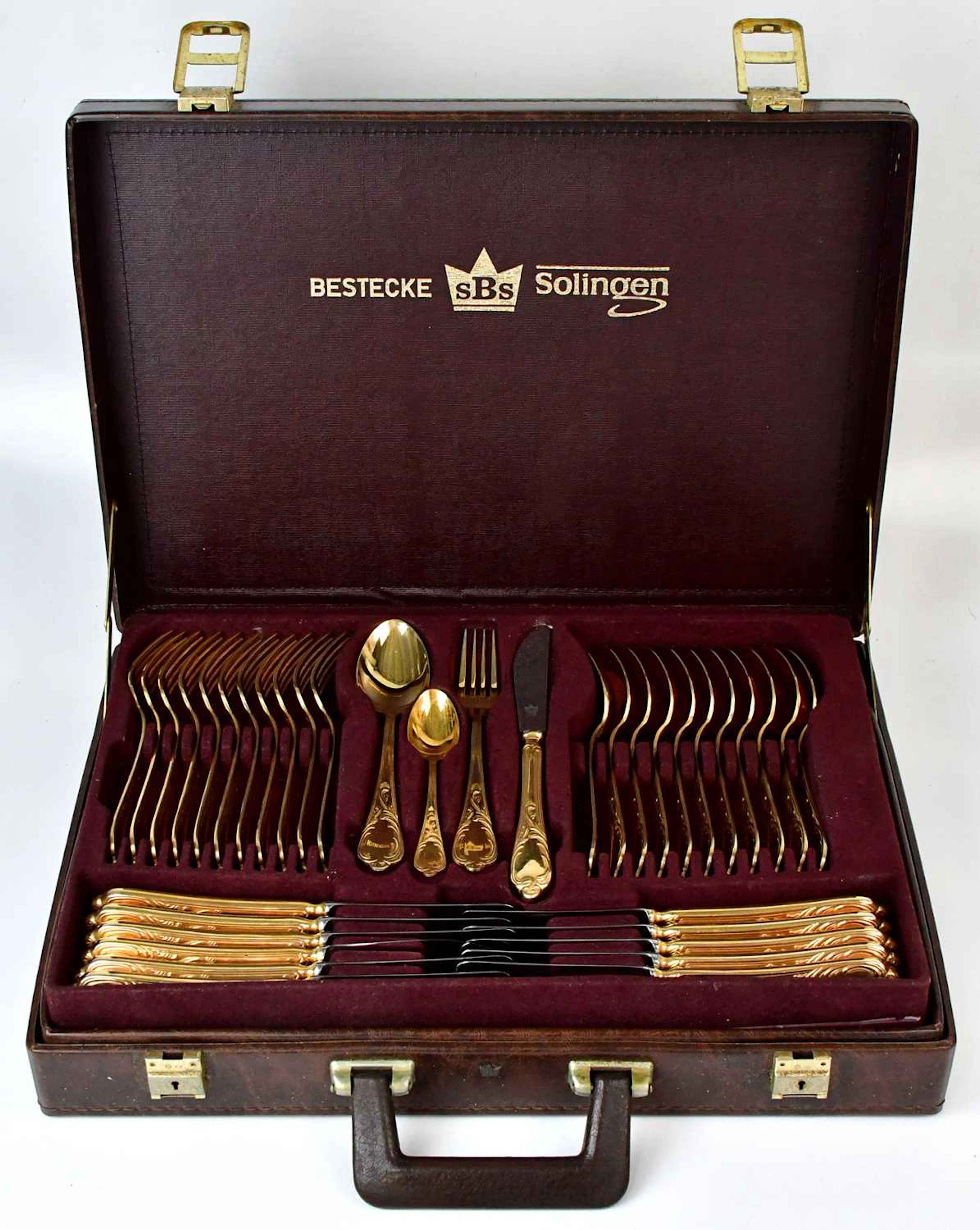 A Bestecke Solingen gold-plated canteen of cutlery for twelve place settings