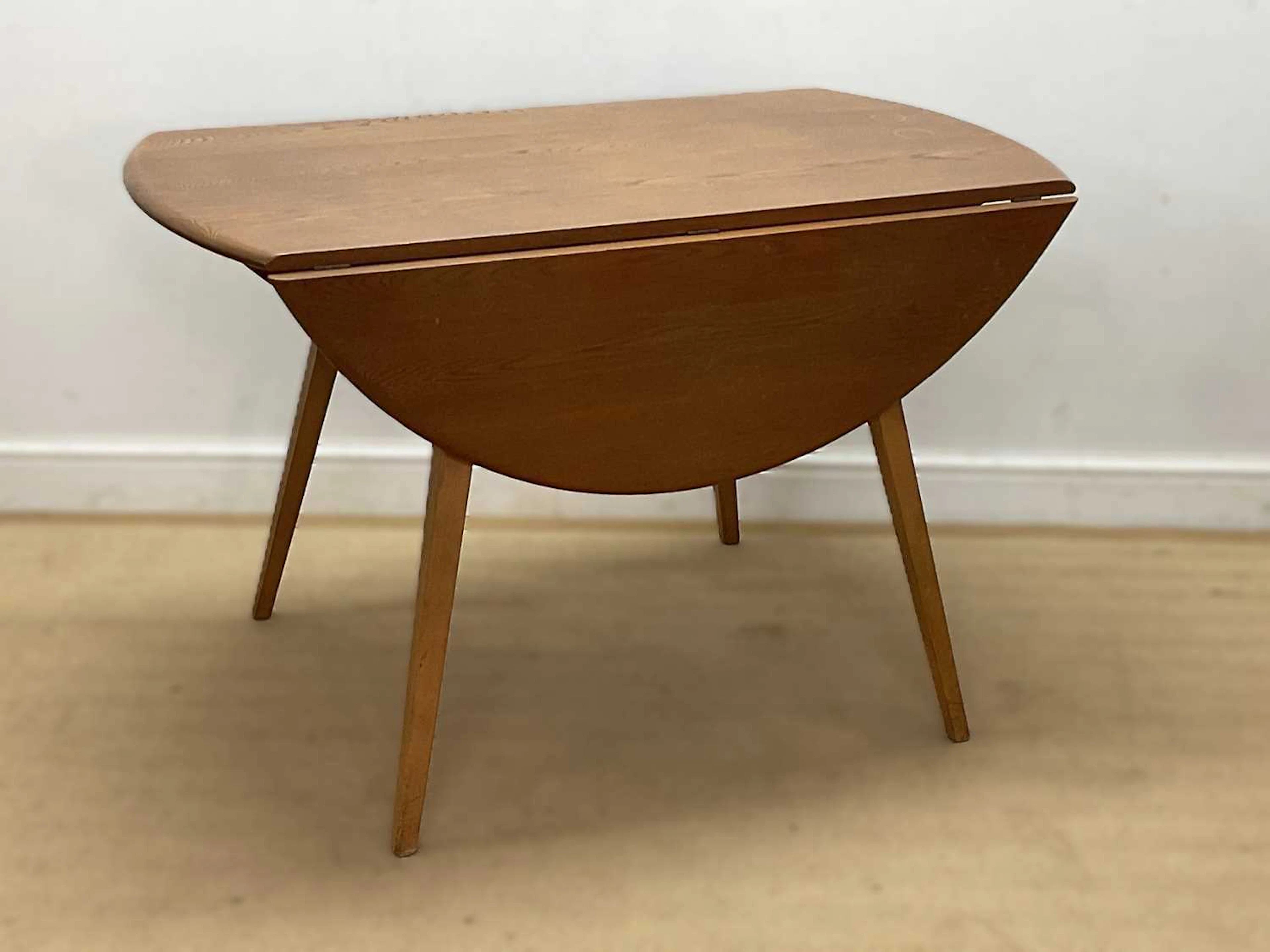 ERCOL; a beech and elm 'Windsor' drop-leaf table