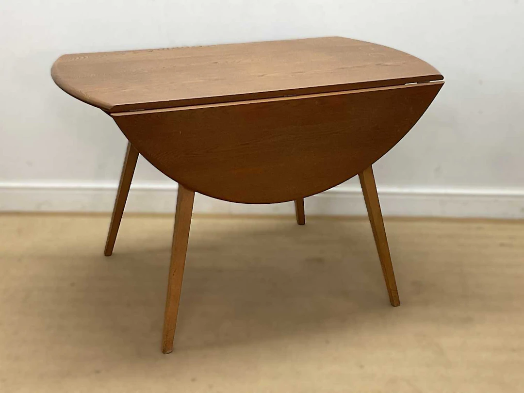 ERCOL; a beech and elm 'Windsor' drop-leaf table