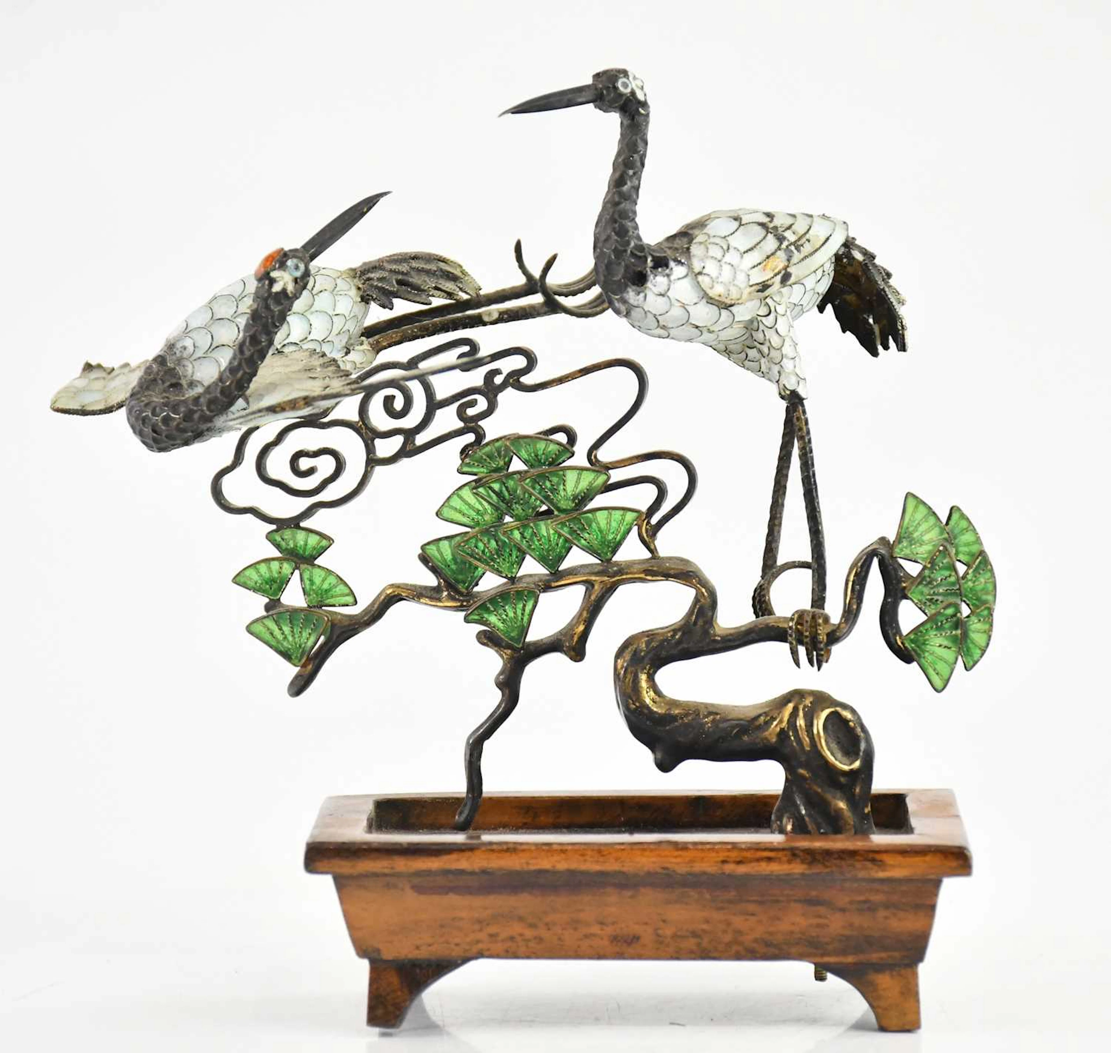 A Japanese white metal and enamel model of two cranes