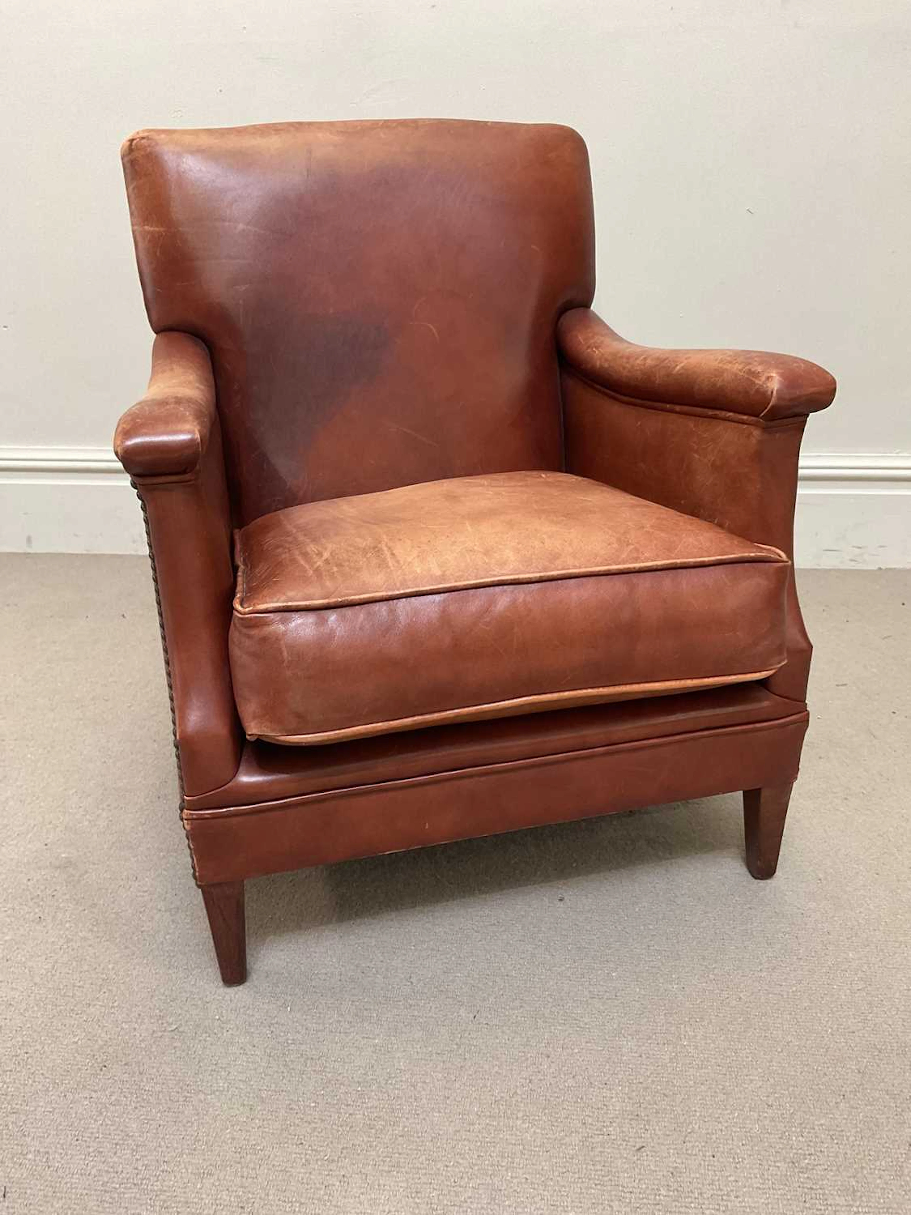 A modern tan leather library chair