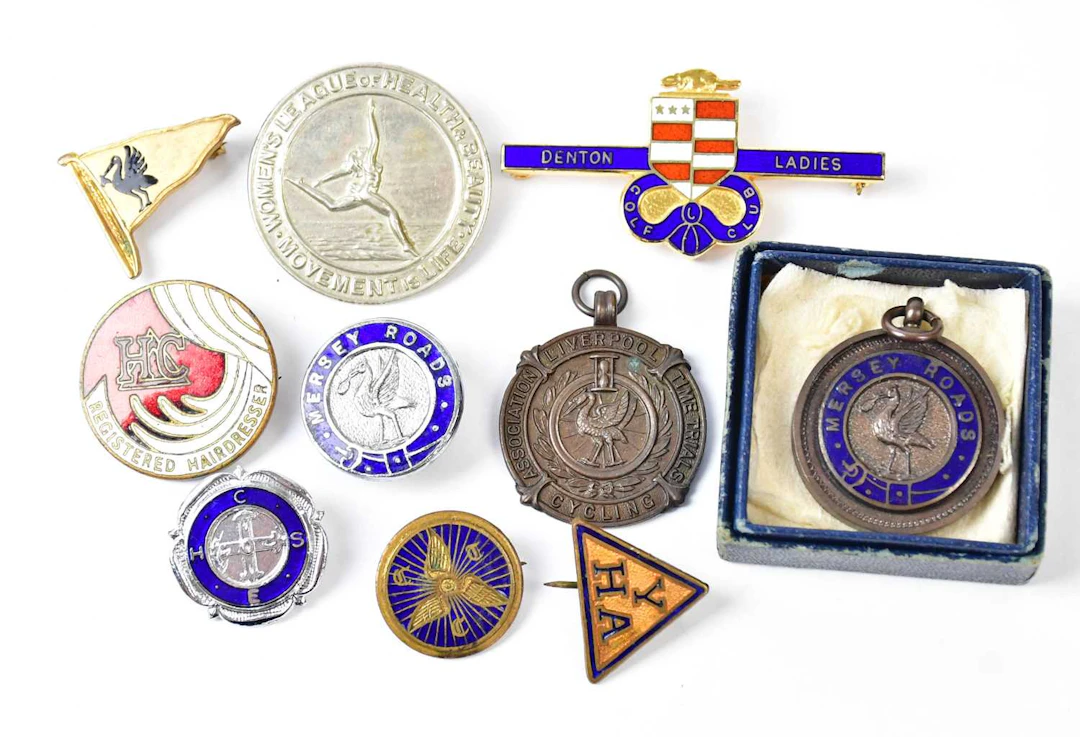 A collection of sporting and other badges