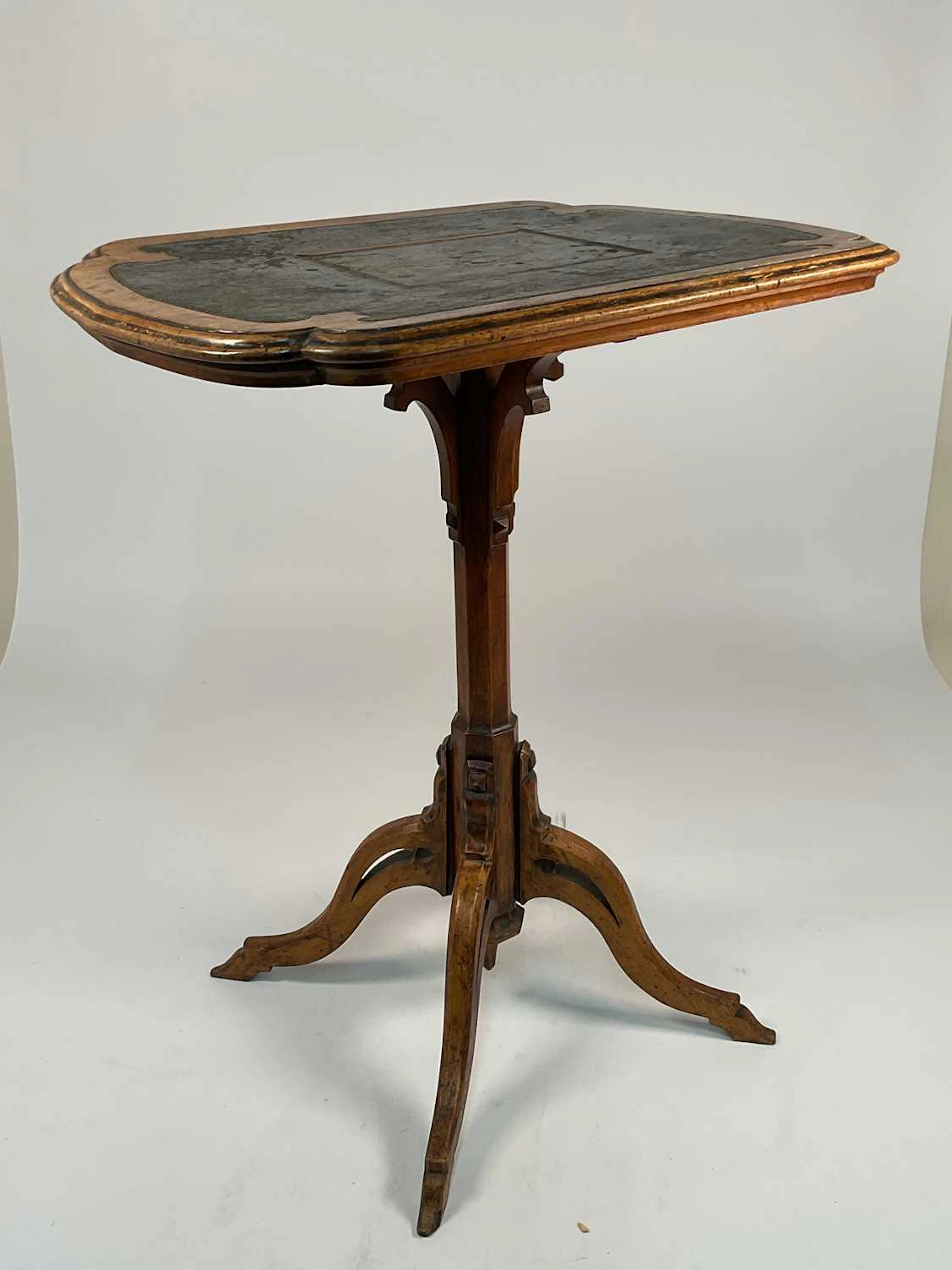 A mahogany occasional table with leather inset top on four splayed supports