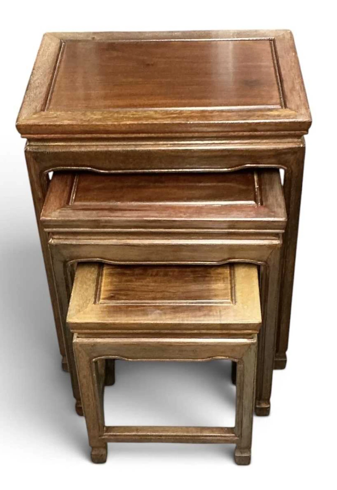 A modern Chinese carved hardwood nest of three occasional tables