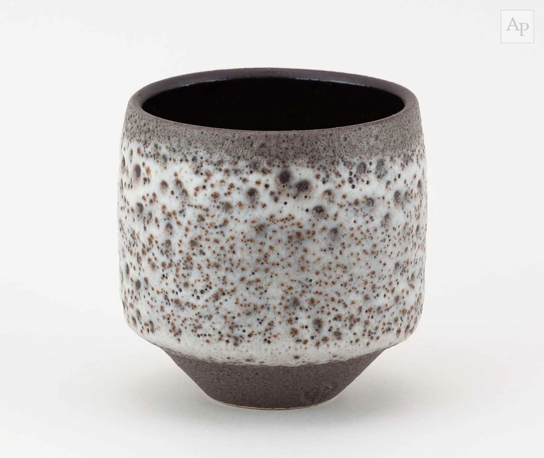 CHRIS JENKINS (1933-2022); a stoneware cup covered in volcanic glaze