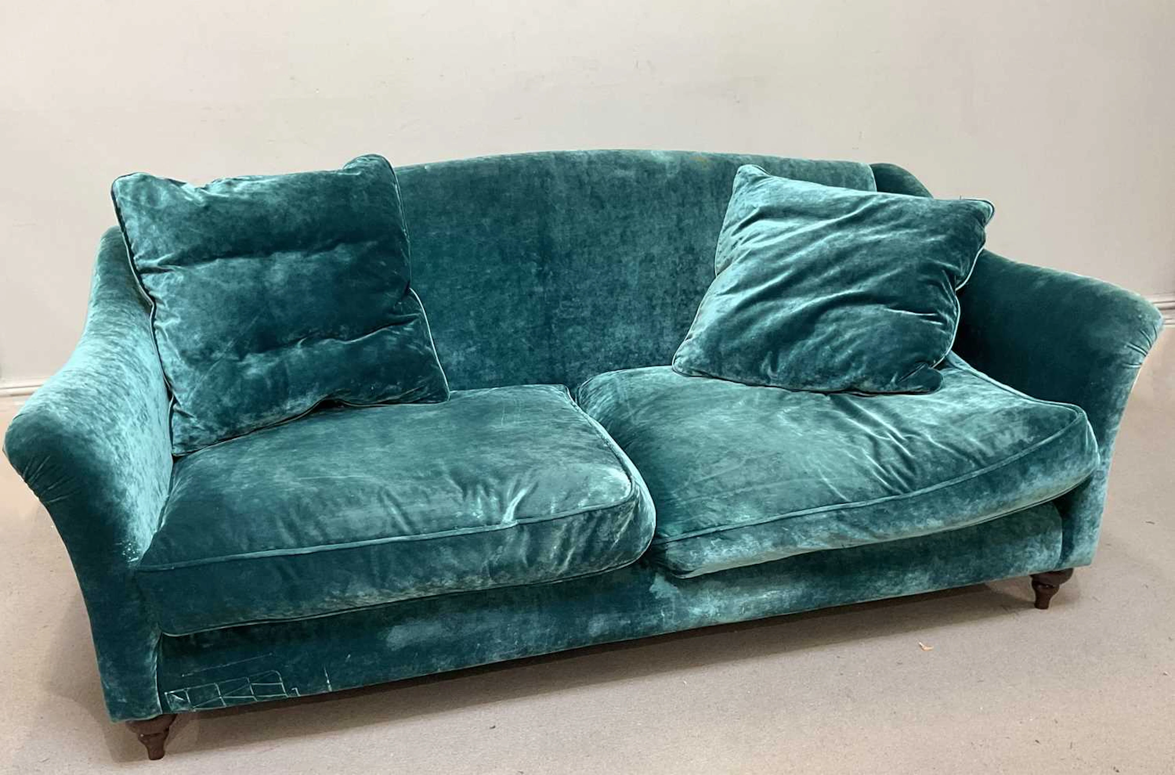 A contemporary two seater sofa with blue upholstery and label for Spink & Edgar