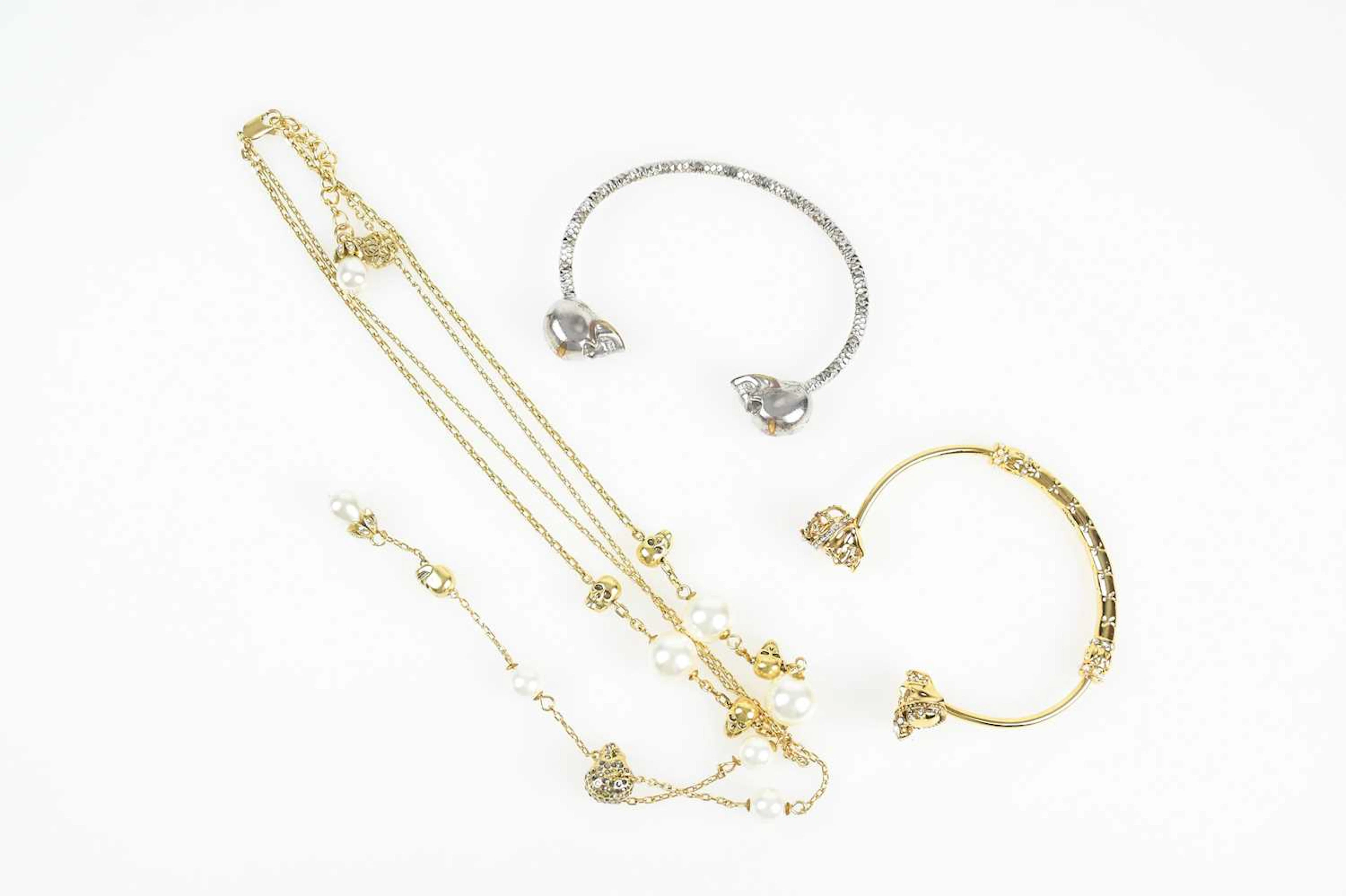 ALEXANDER MCQUEEN; a gold tone bracelet embellished with...