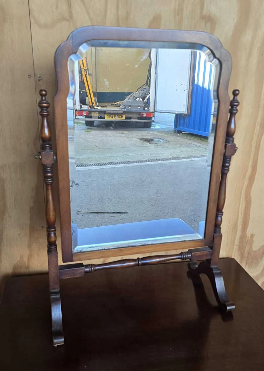 A mahogany swivel mirror with bevelled edge