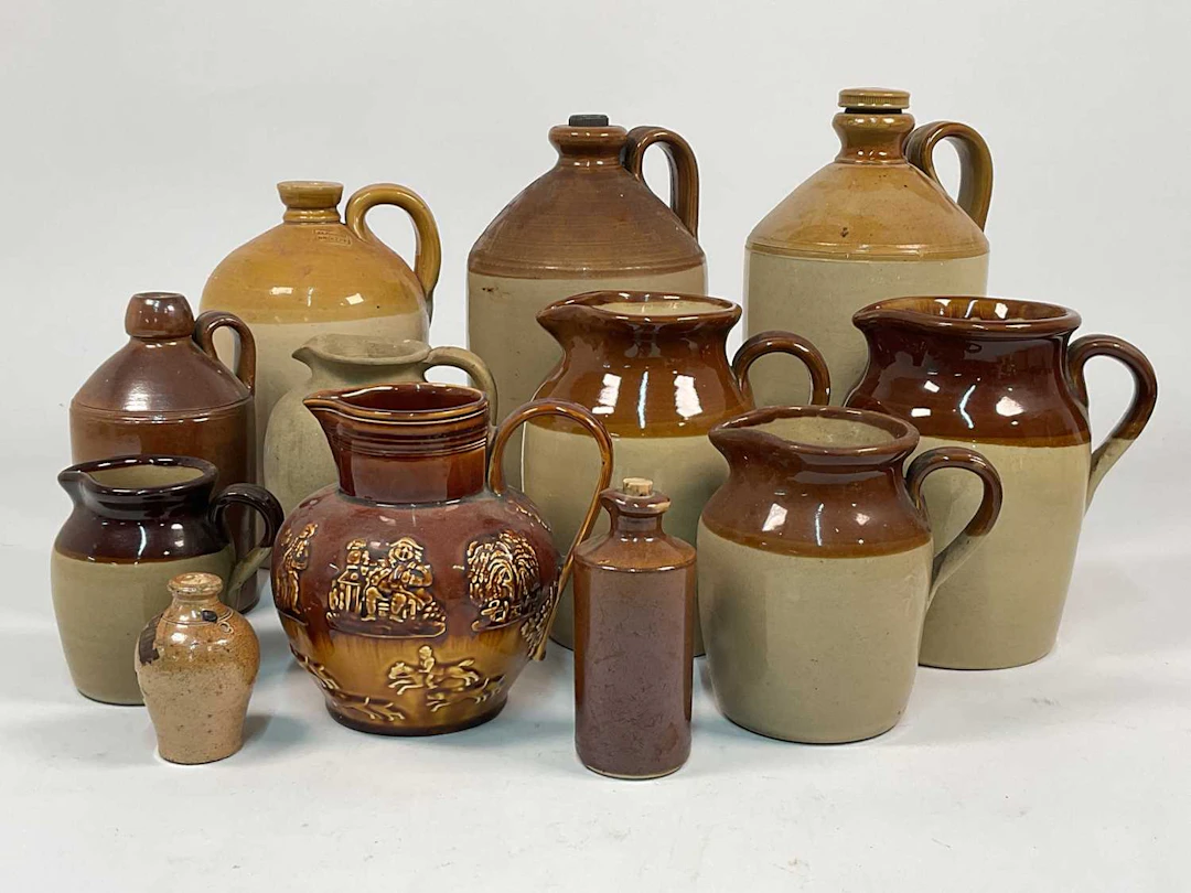 A quantity of stoneware and salt glazed flagons