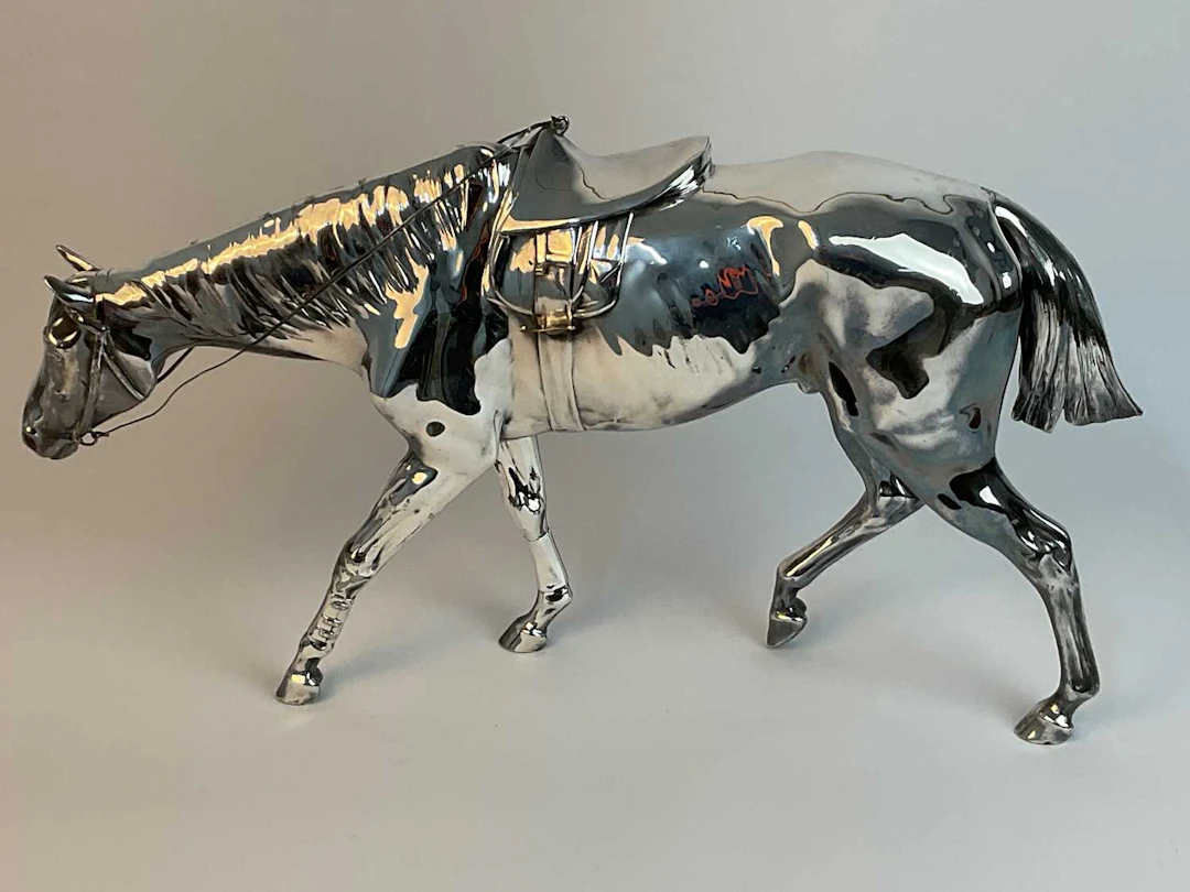 A metal sculpture of a race horse