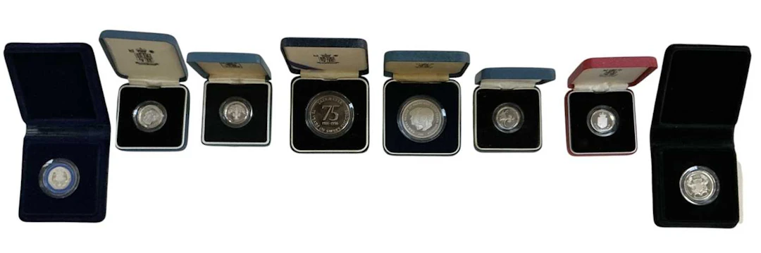 Eight assorted cased encapsulated silver proof coins