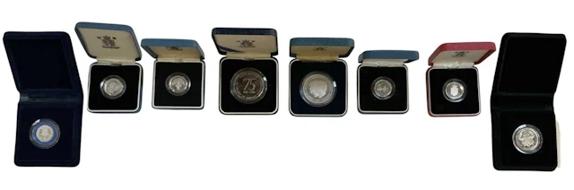 Eight assorted cased encapsulated silver proof coins