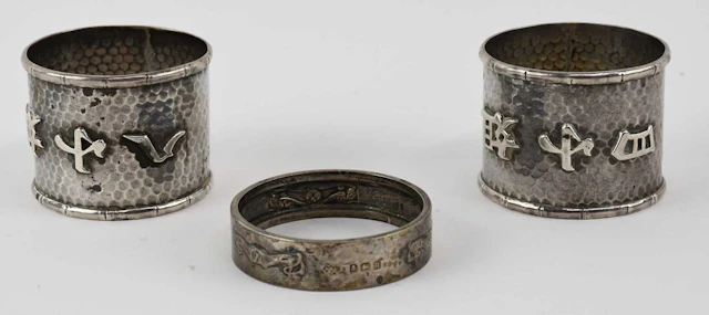 LIBERTY & CO; a George V hallmarked silver Art Nouveau napkin ring