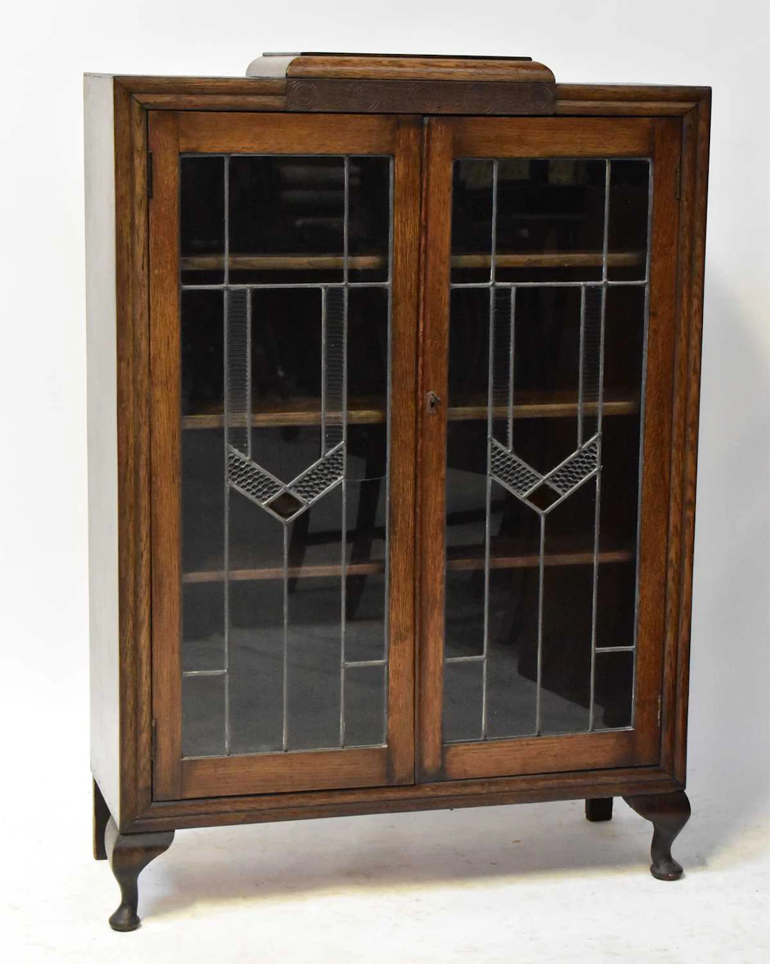 A 1930s oak display cabinet