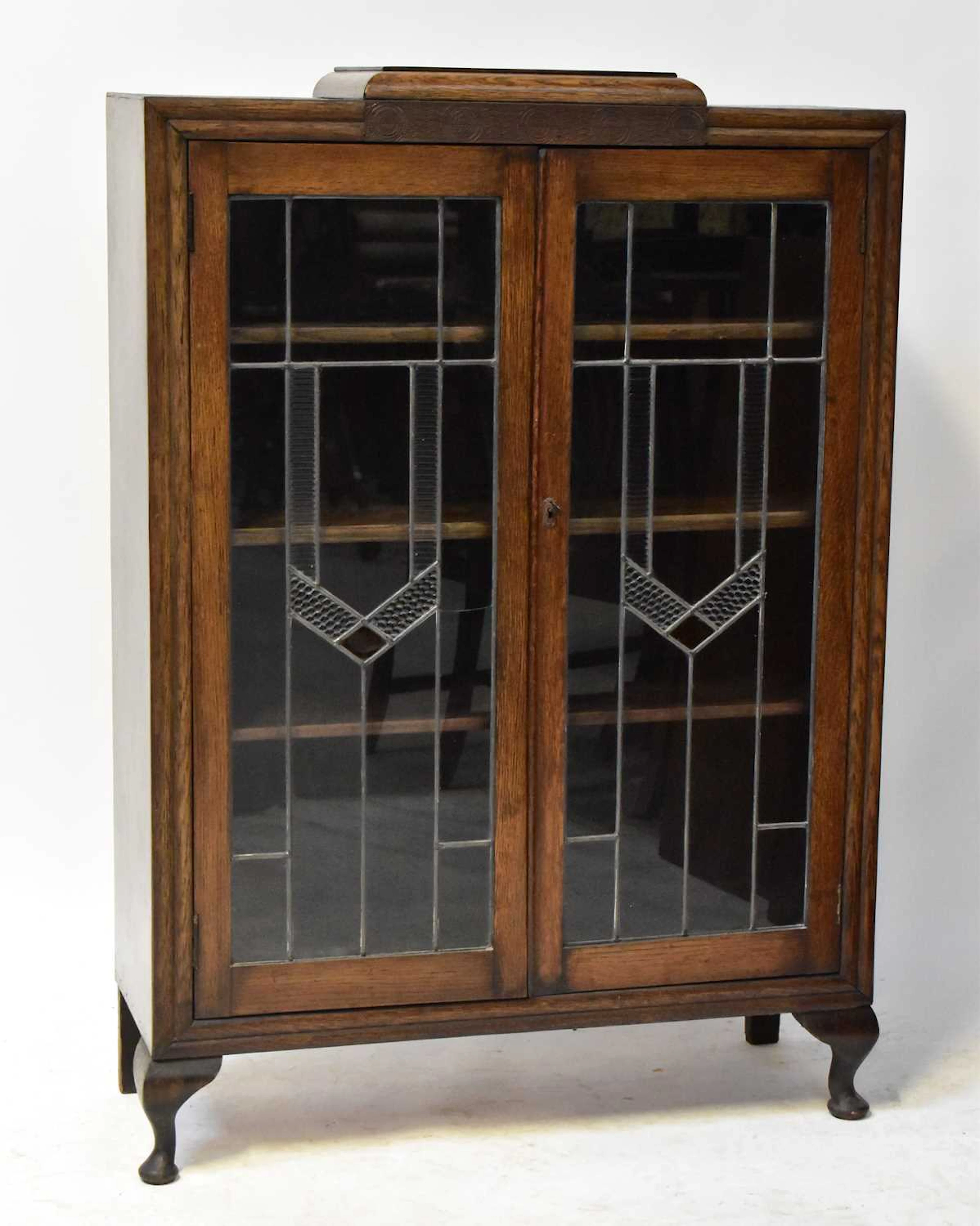 A 1930s oak display cabinet