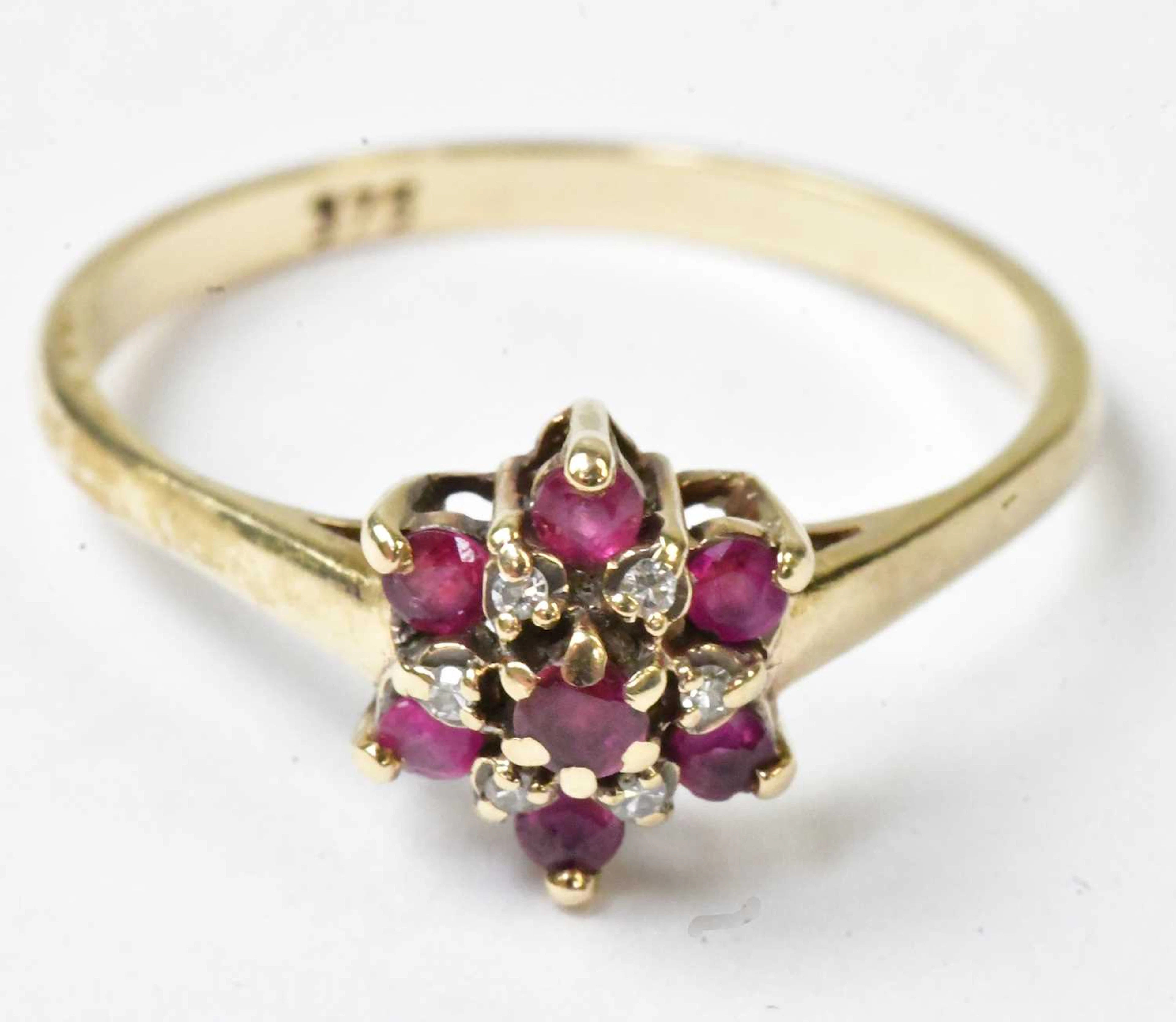 A 9ct yellow gold floral cluster ring set with seven red...