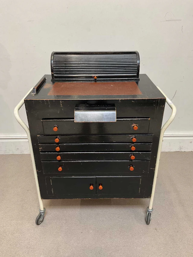 A vintage stained wood optician's chest