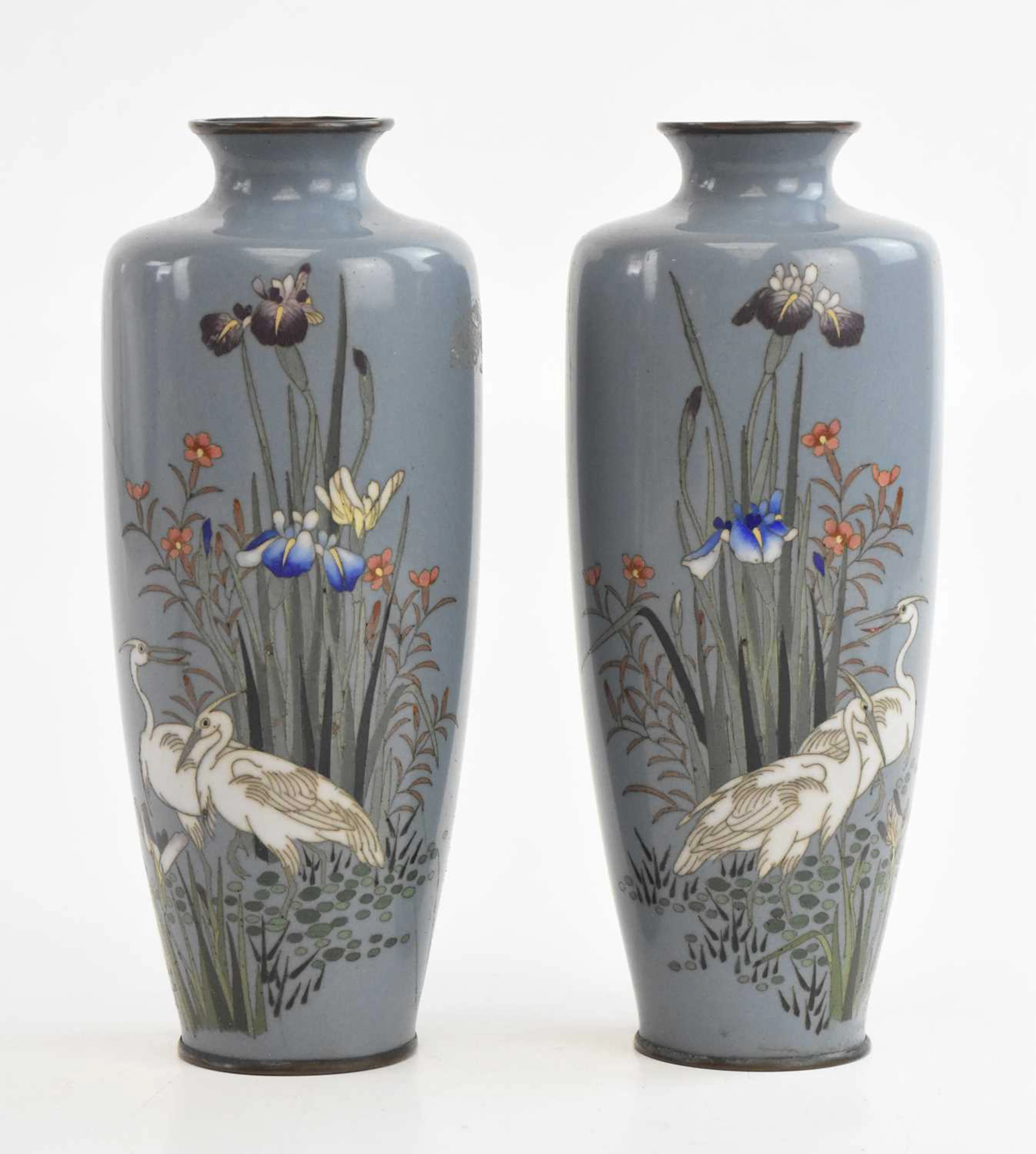 A pair of Japanese cloisonné vases decorated with cranes amongst reeds