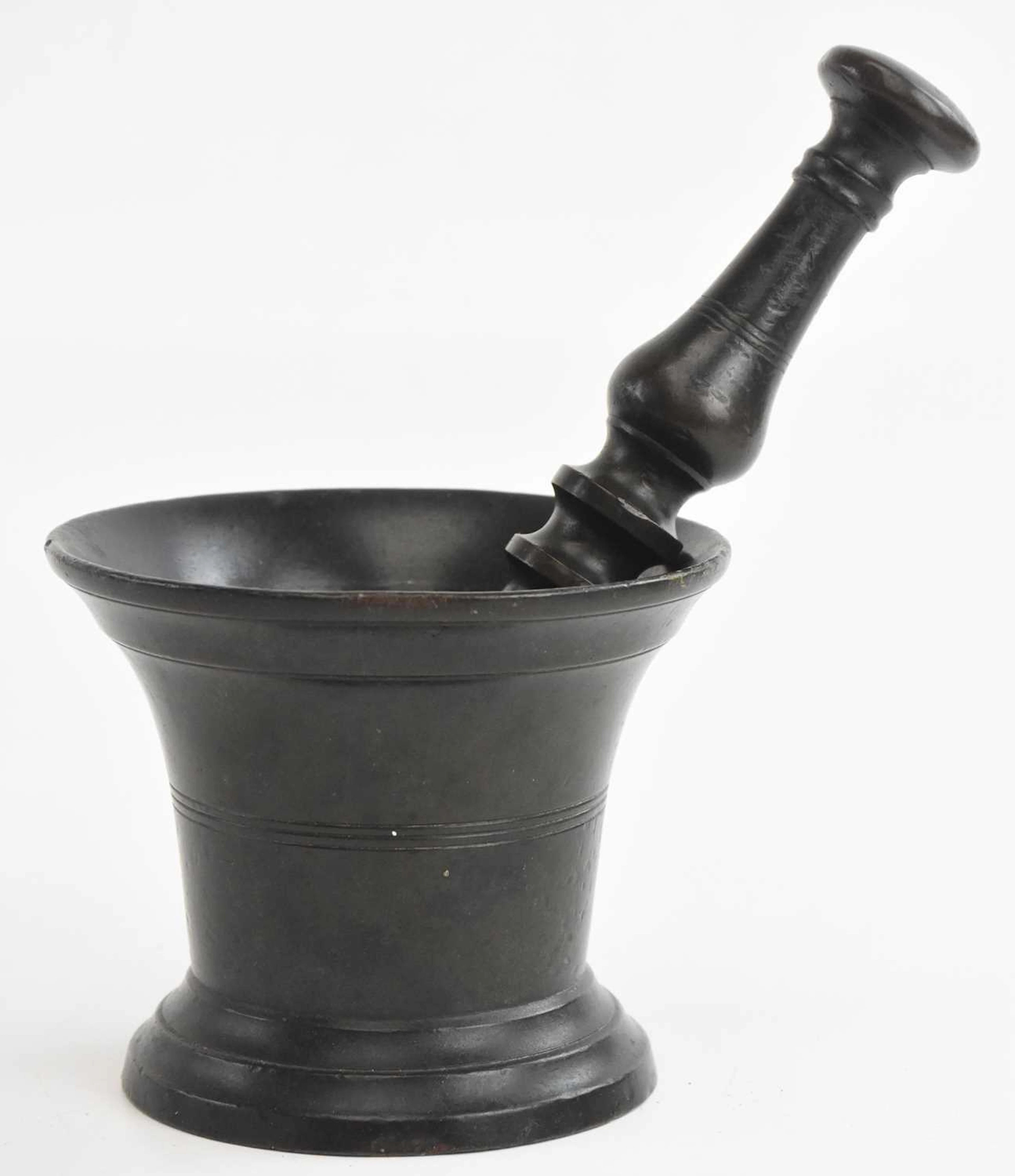 A bronze pedestal and mortar