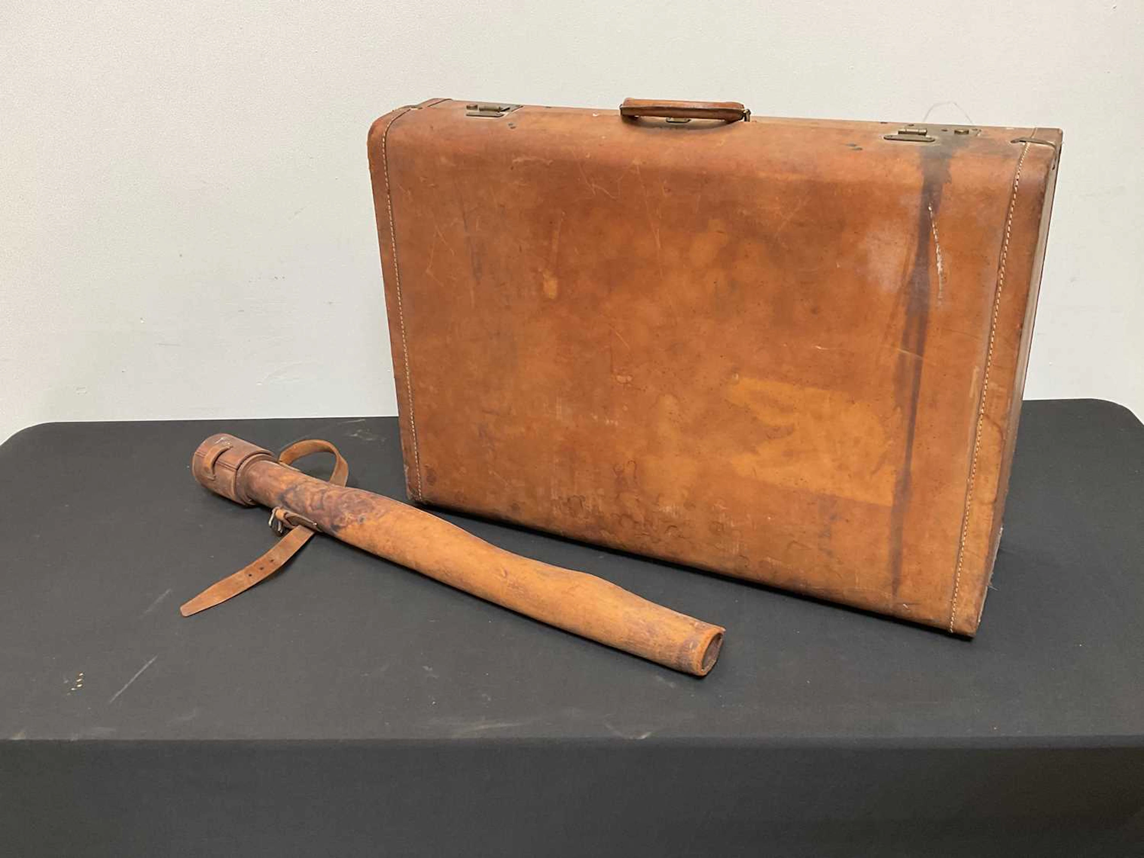 A leather suitcase and a sword case