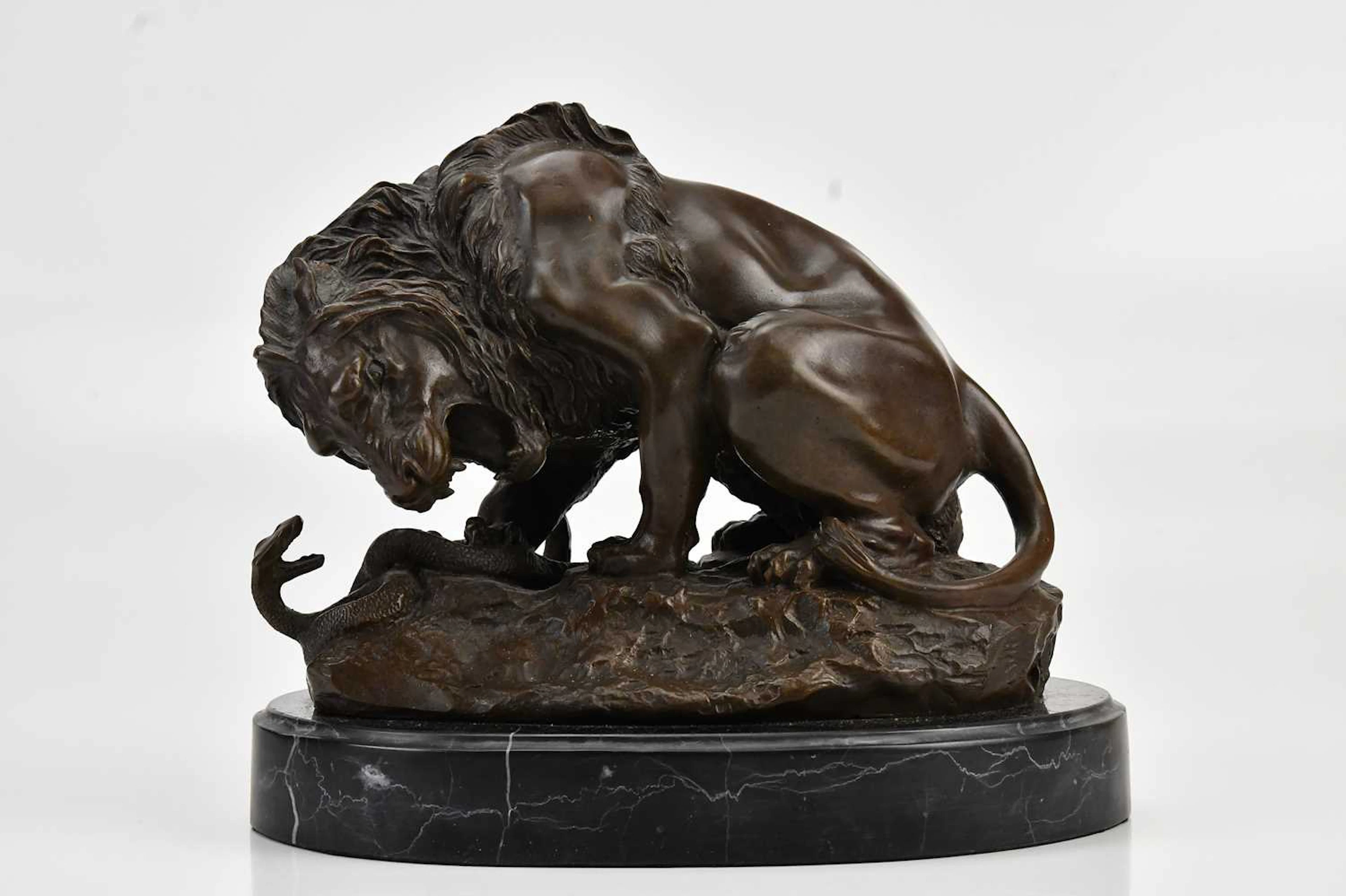 AFTER ANTOINE-LOUIS BARYE; a bronze figure of a lion and snake