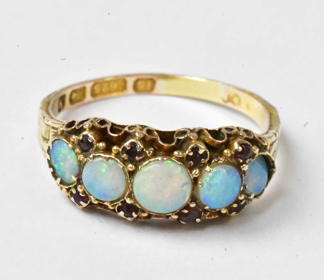 A 15ct yellow gold ring set with five graduated opal...