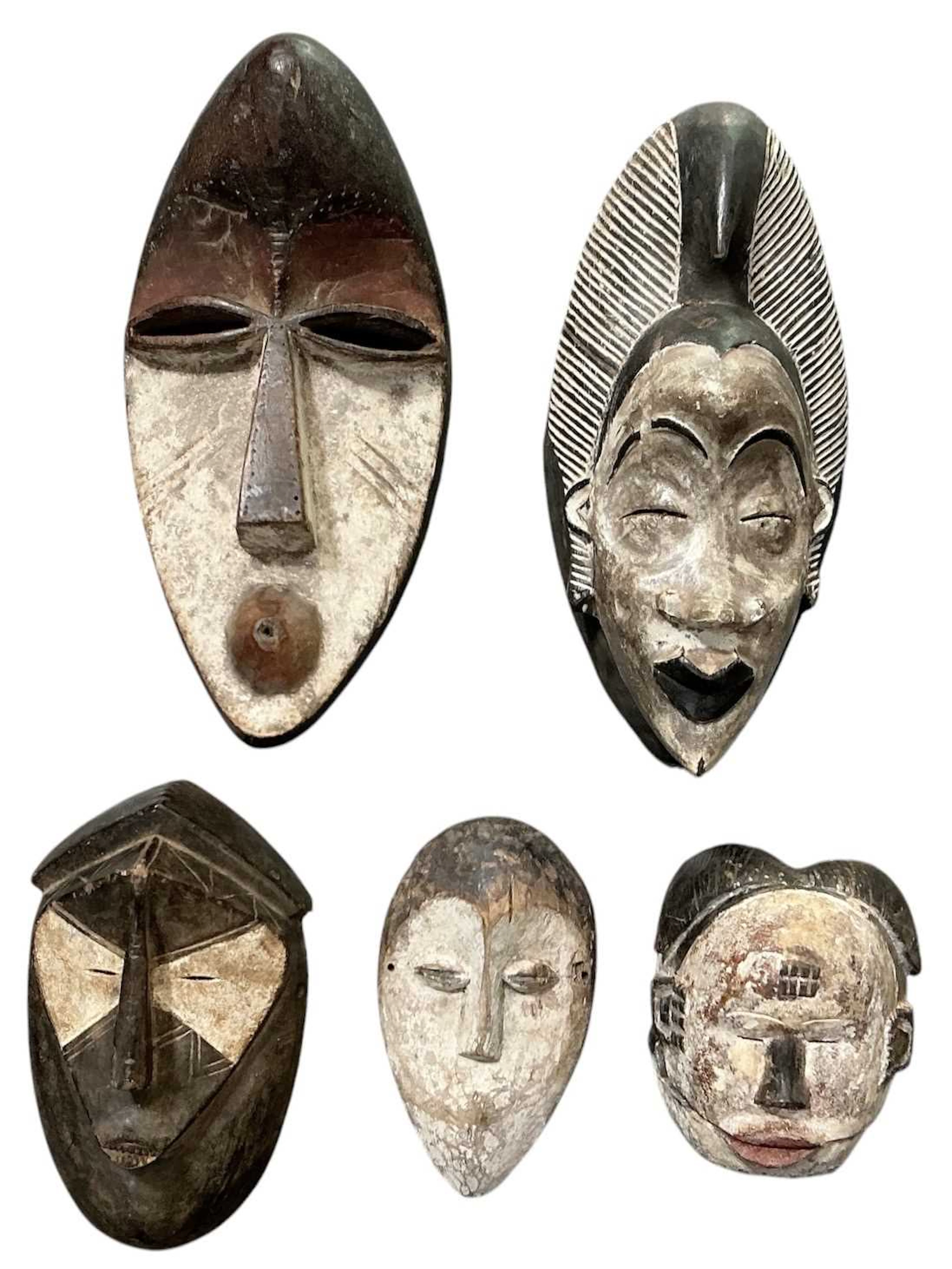 Five assorted African tribal carved wooden painted masks