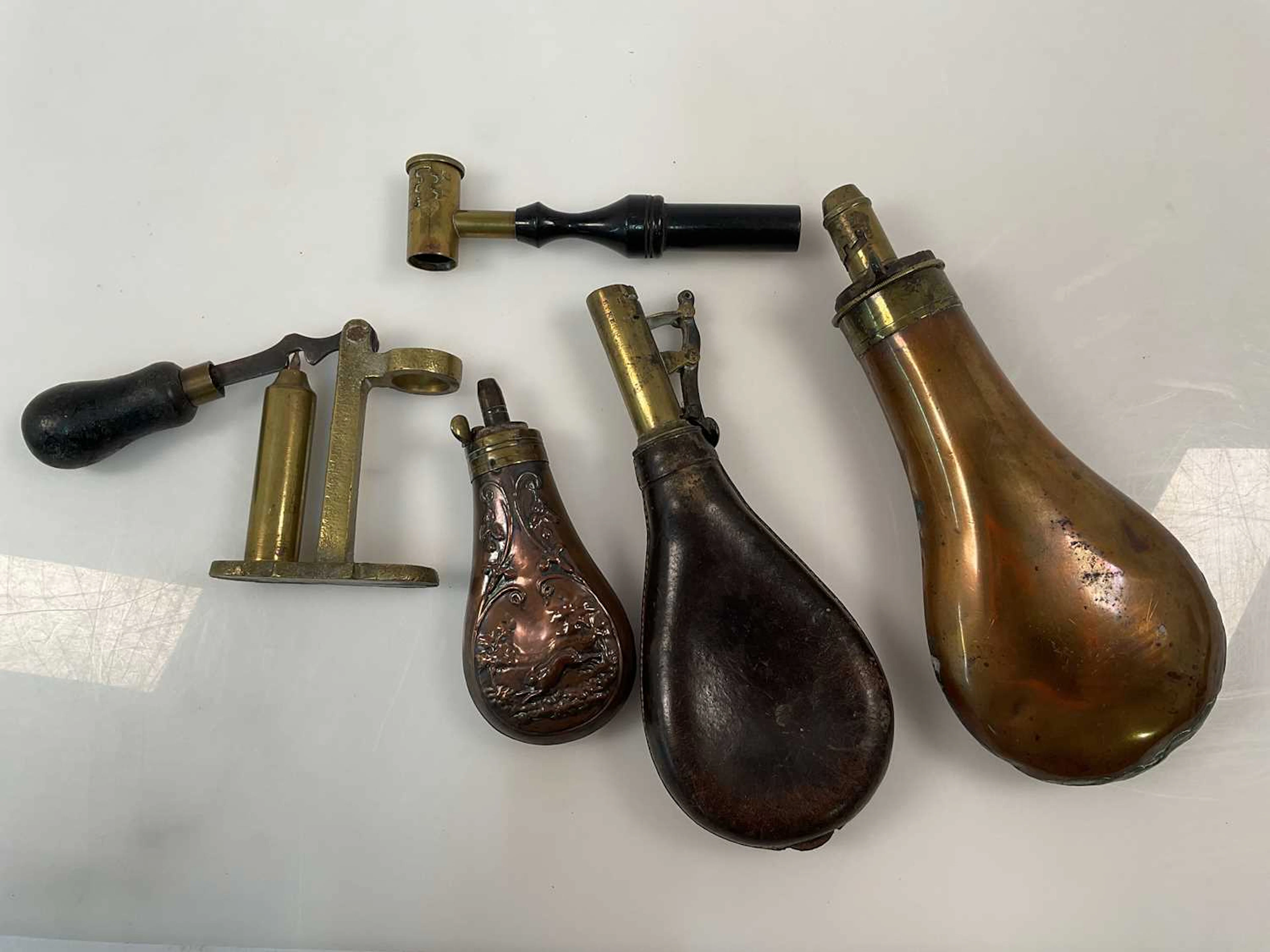 A cartridge maker and powder flasks