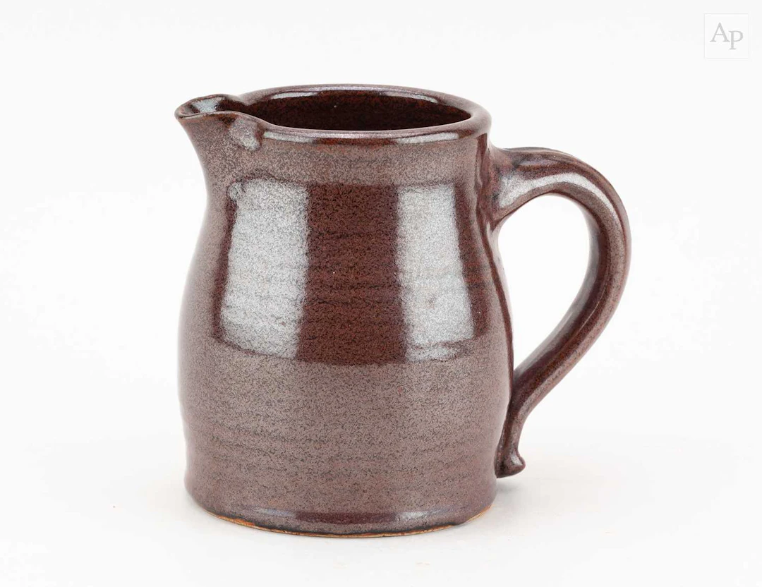 DAN ARBEID (1928-2010); a stoneware jug covered in iron rich glaze