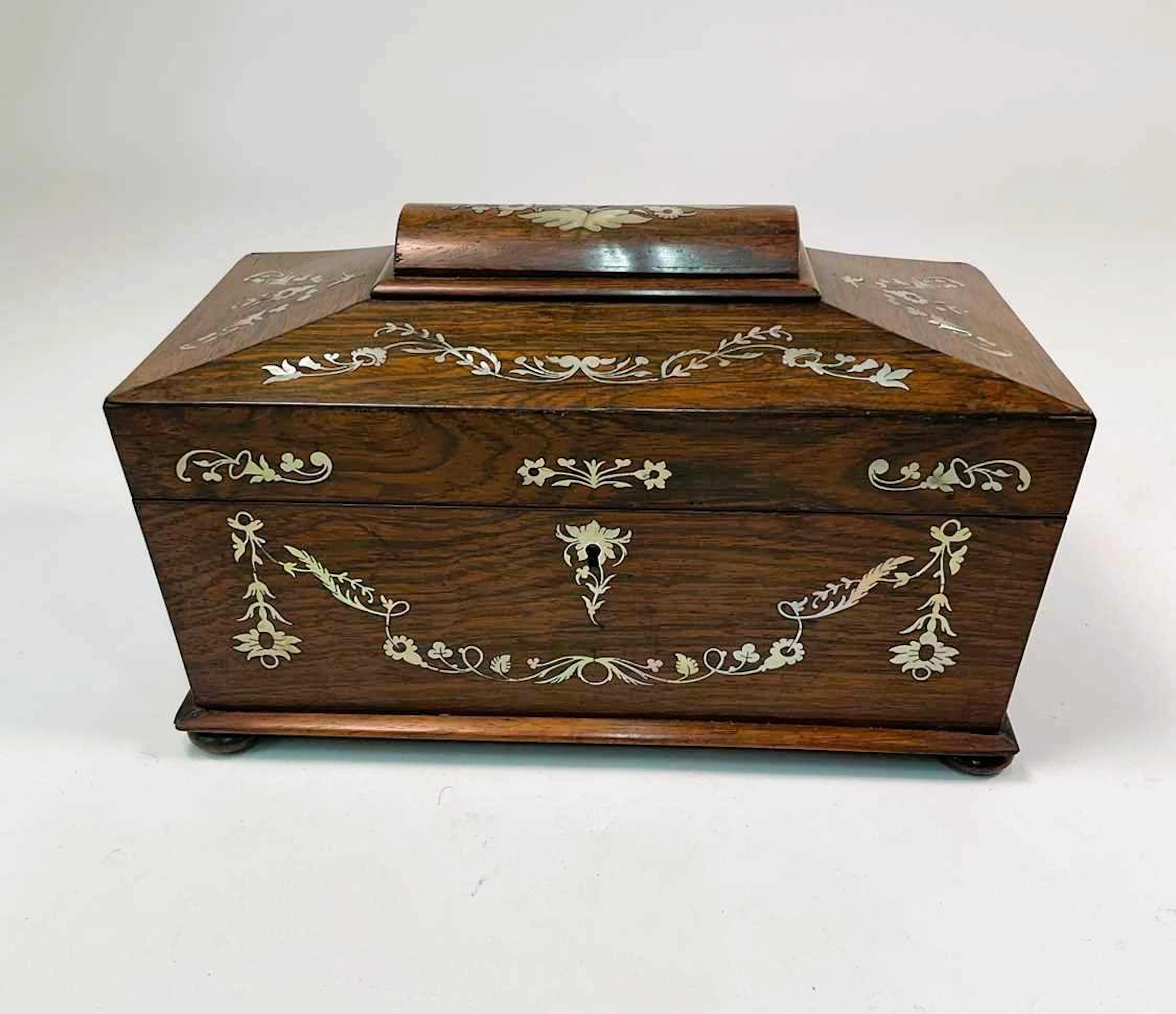 A 19th century rosewood and mother of pearl inlaid sarcophagus tea caddy
