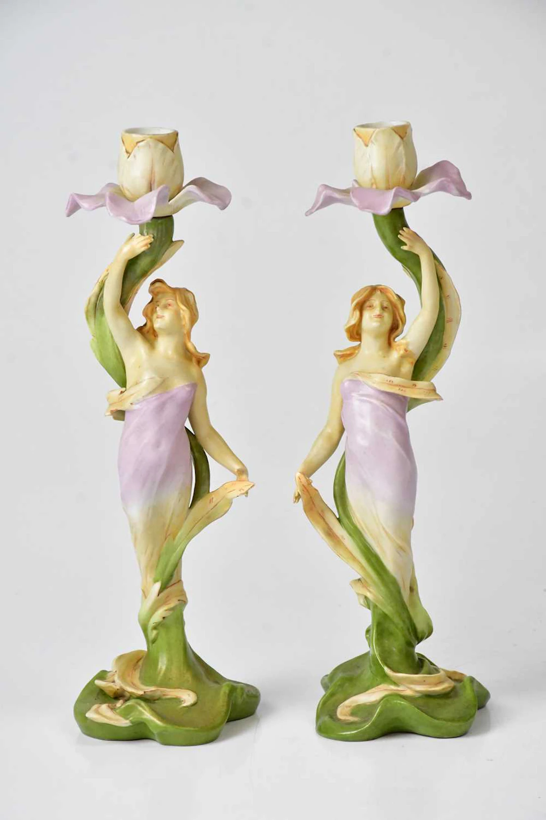 VOLKSTEDT; a pair of porcelain Art Nouveau candlesticks...