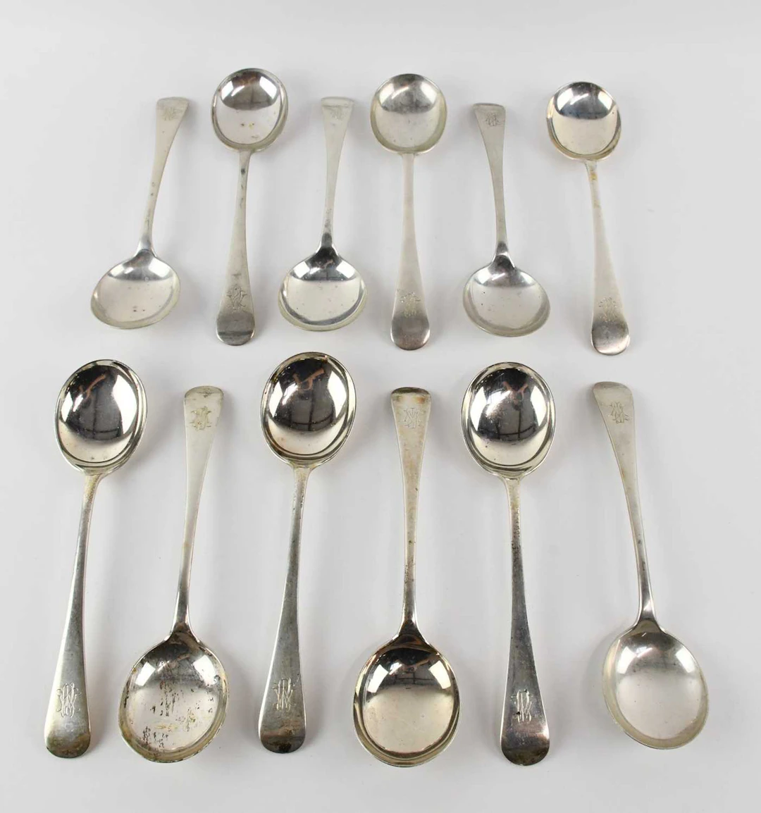 MAPPIN & WEBB LTD; a set of twelve George V hallmarked silver soup spoons