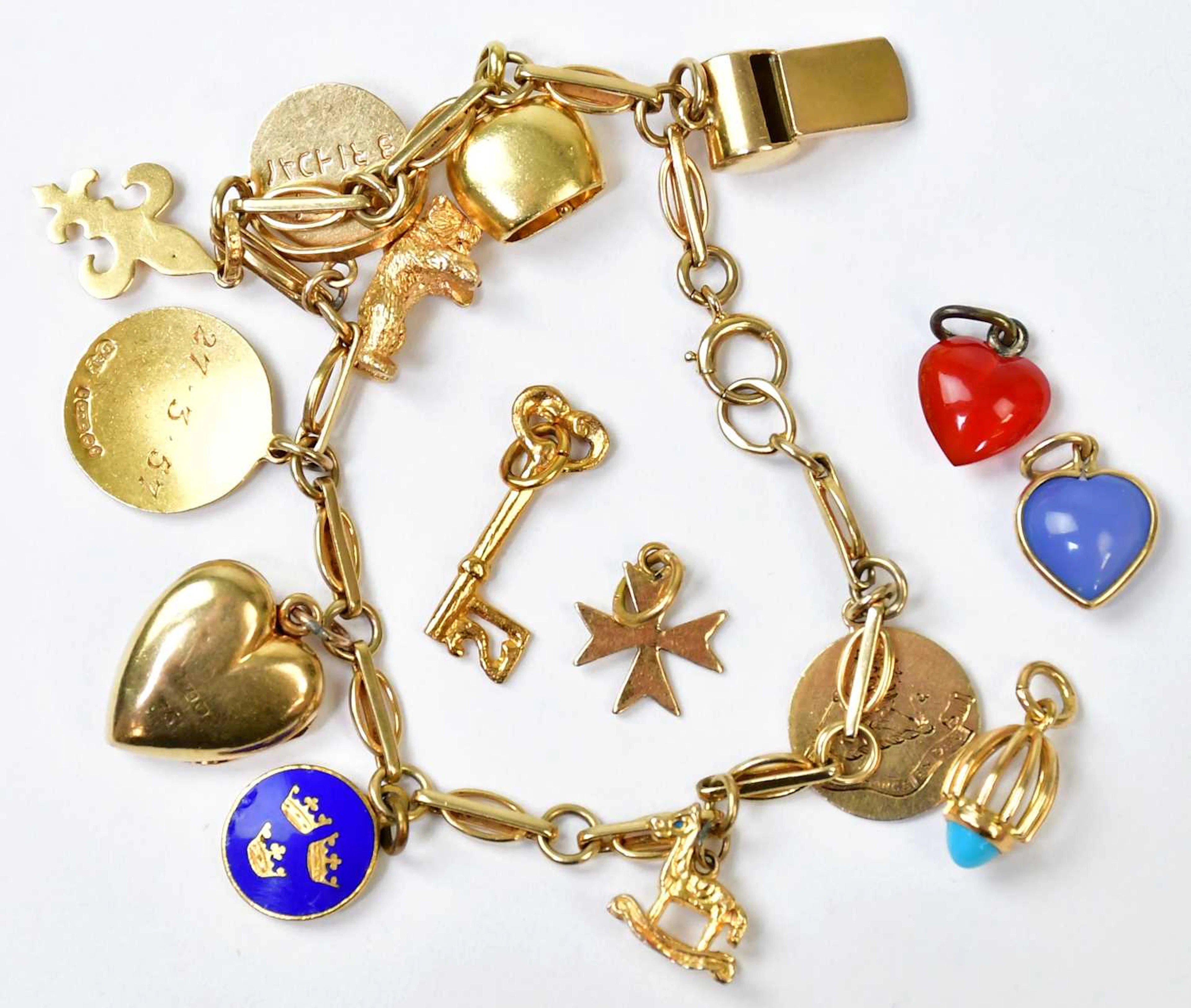 A 9ct yellow gold bracelet set with ten charms