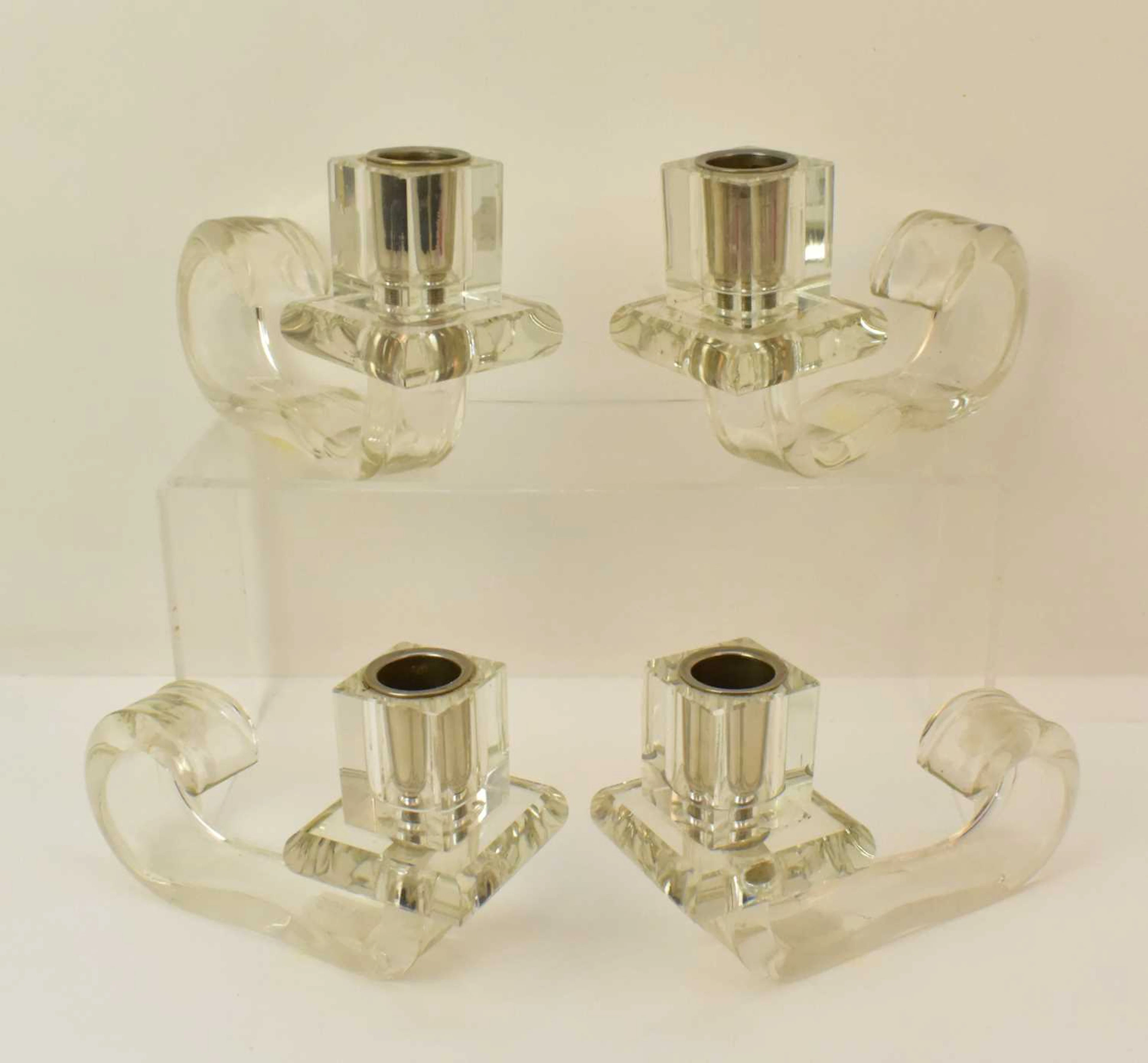 Four contemporary single candlesticks made from press-formed glass