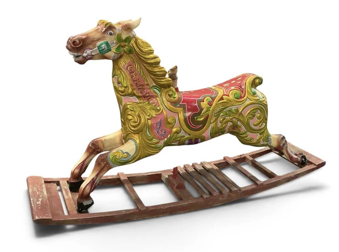 A vintage colourful polychrome painted carved wooden carousel carnival horse
