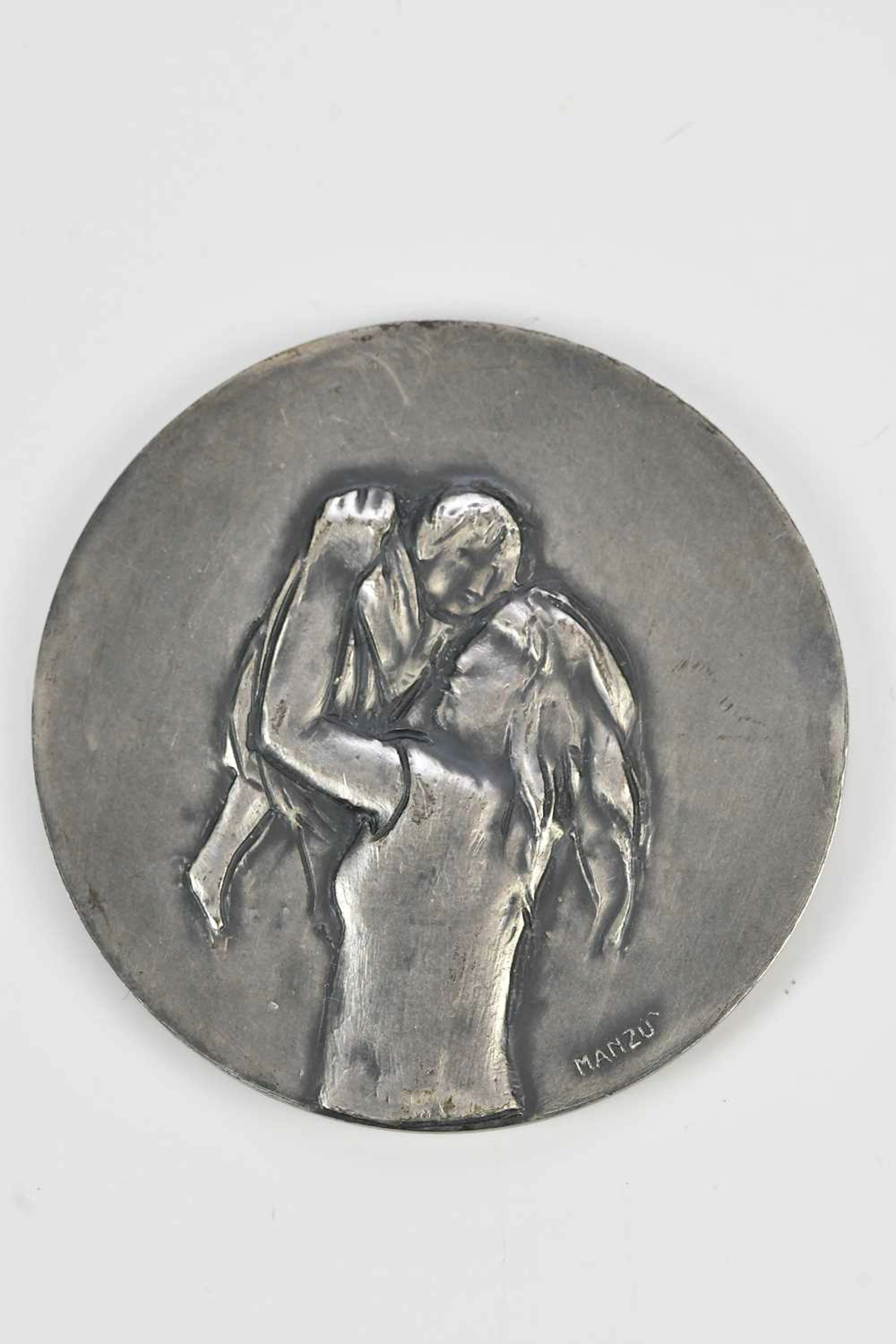 A white metal commemorative medallion for the 40th...