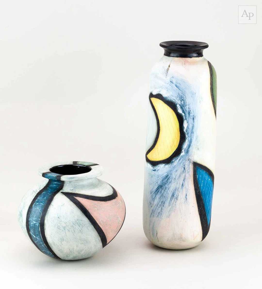 AMANDA BALDWIN; a tall cylindrical slip decorated earthenware bottle
