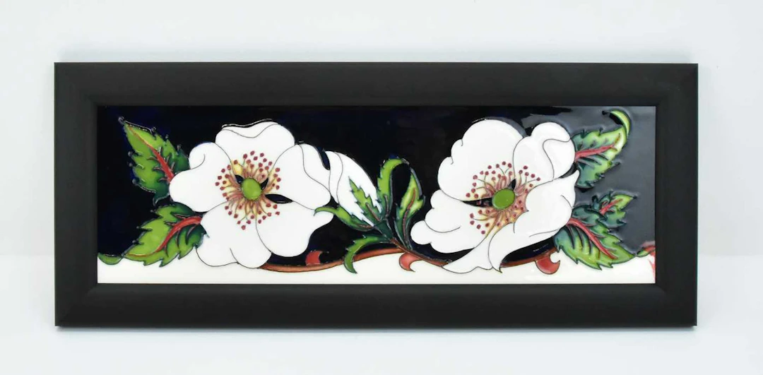 MOORCROFT; a 'White Rose' pattern on cobalt blue plaque