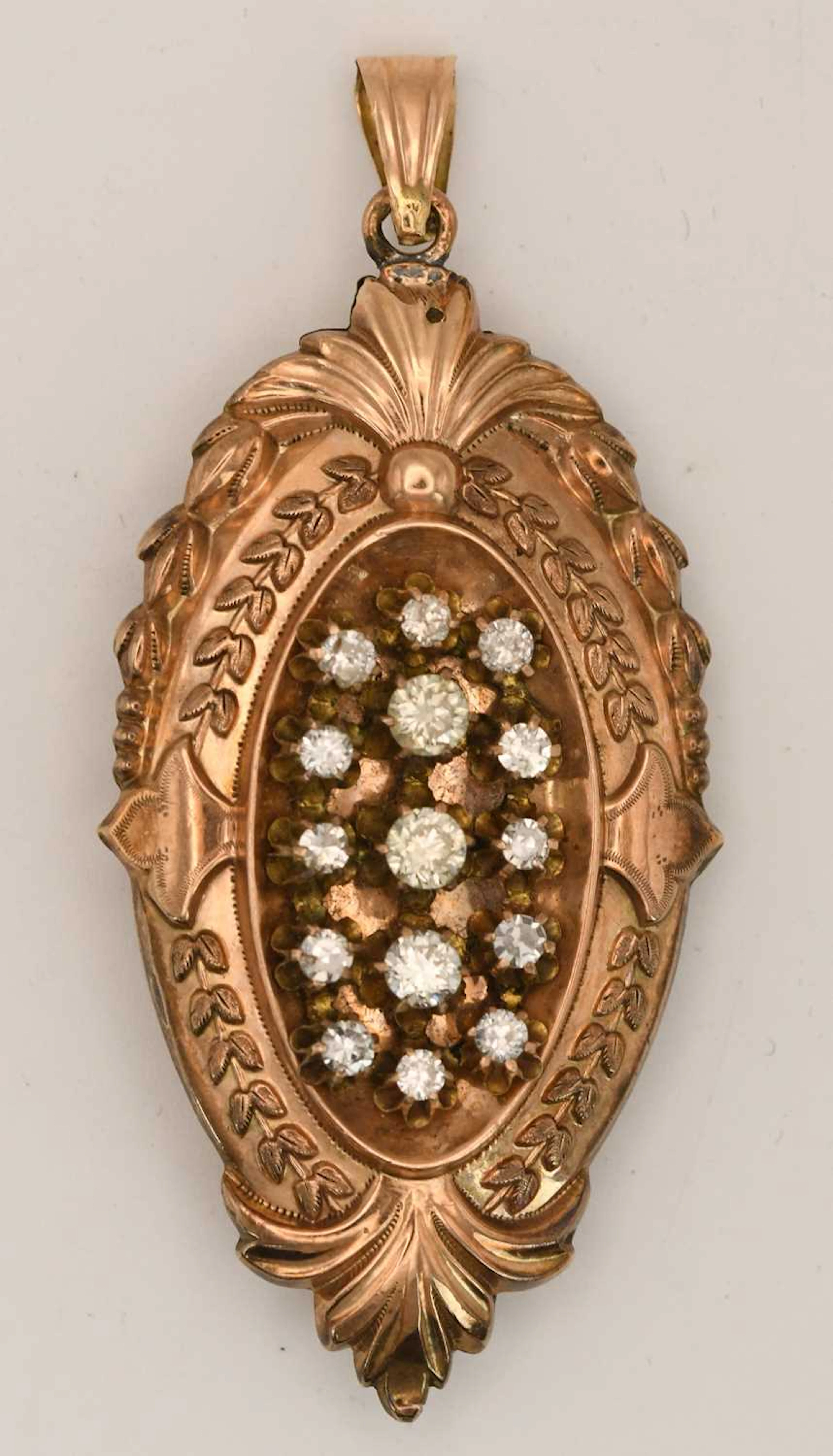 A Victorian yellow metal oval diamond set mourning locket pendant