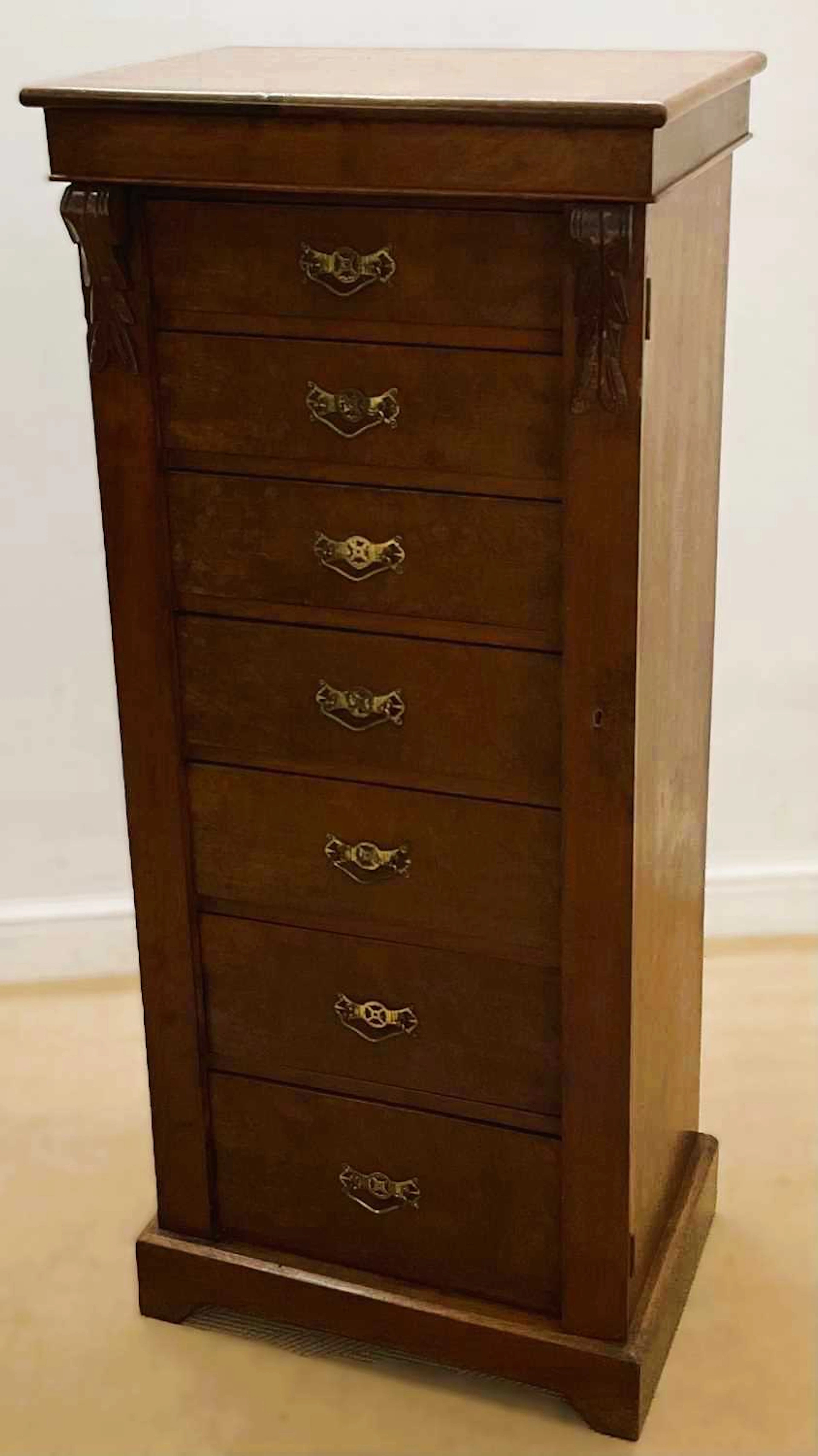 A walnut Wellington chest with seven graduating drawers