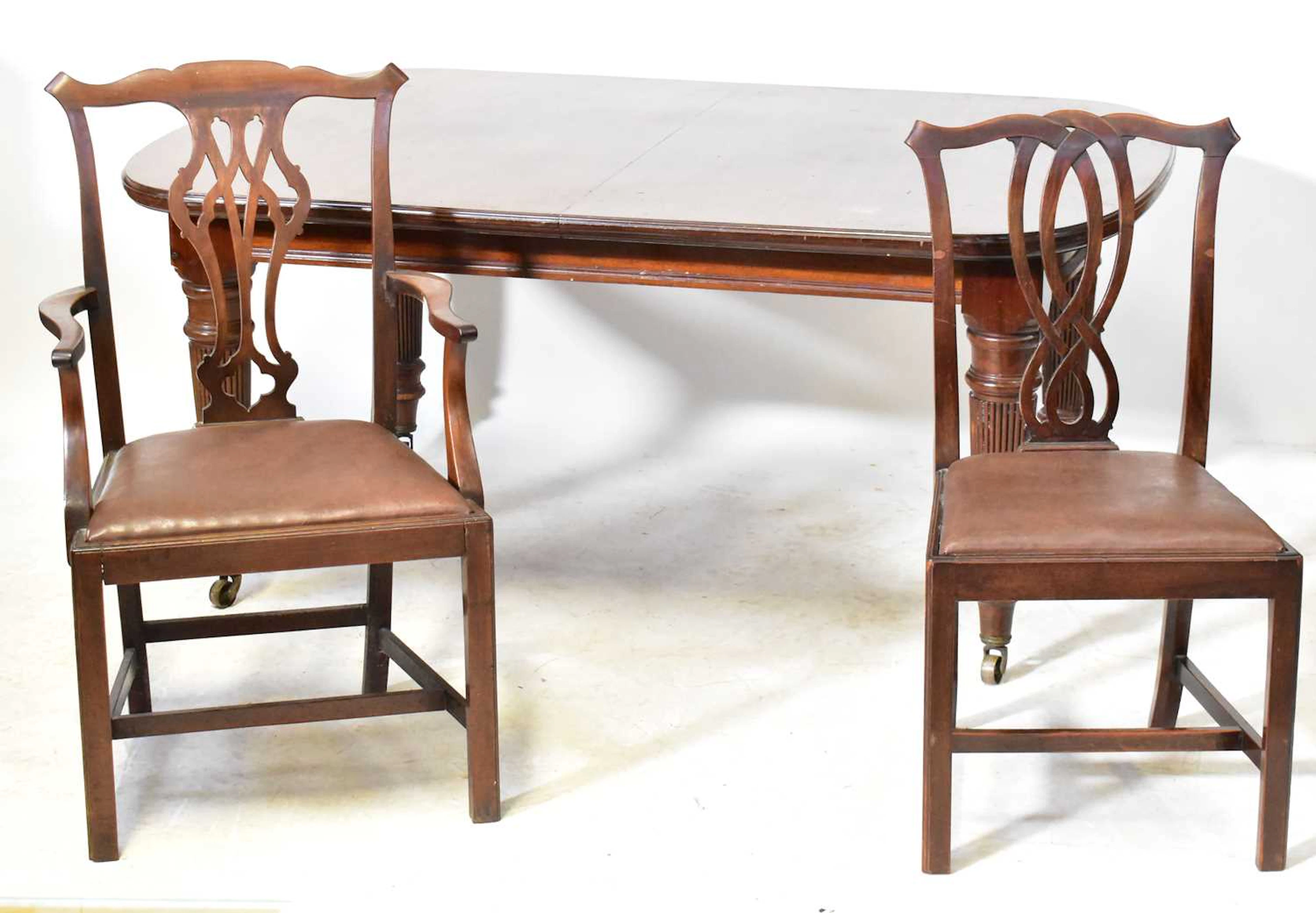 An Edwardian walnut extending dining table