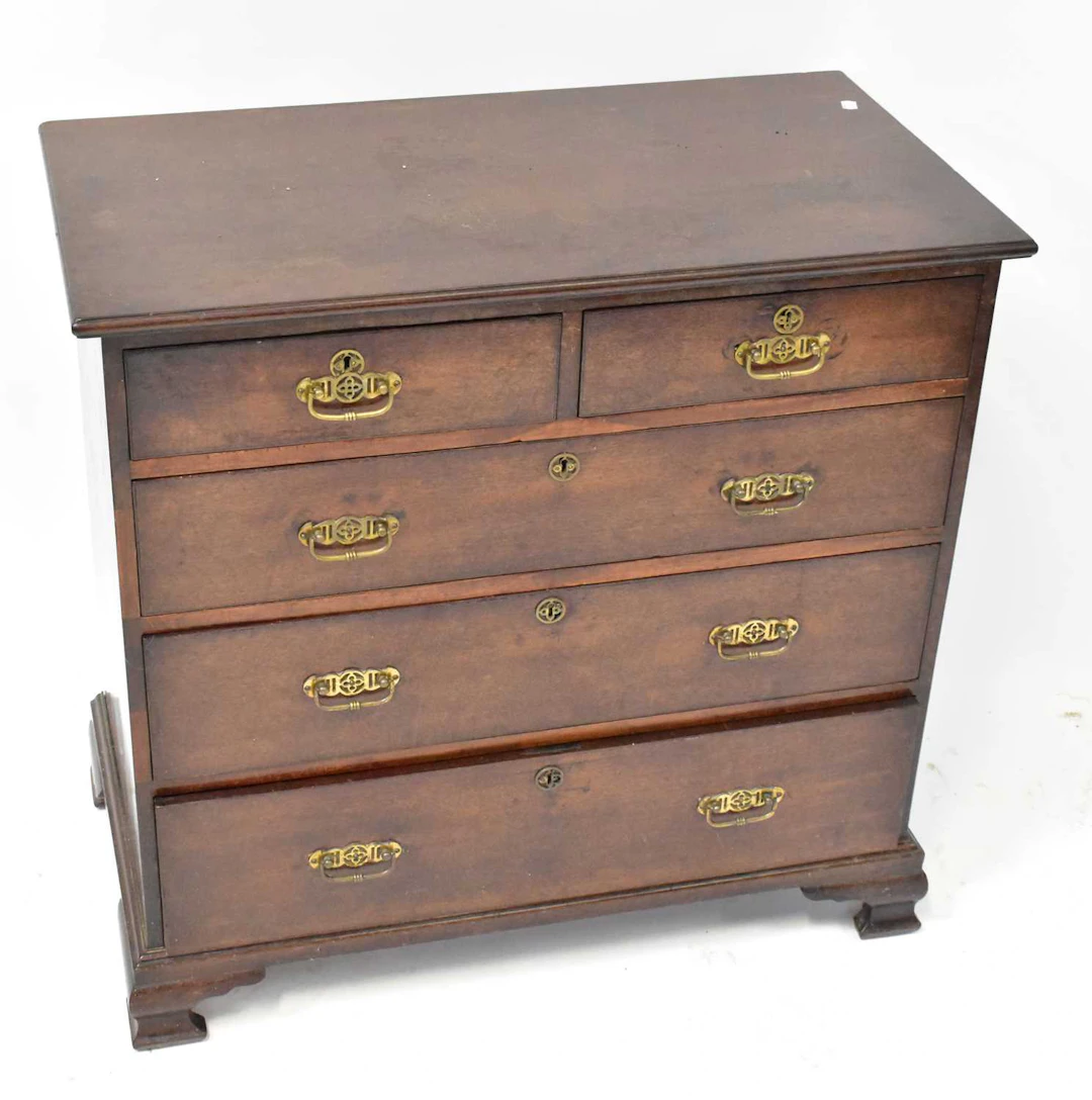 A George III oak chest of two short over three long graduated drawers
