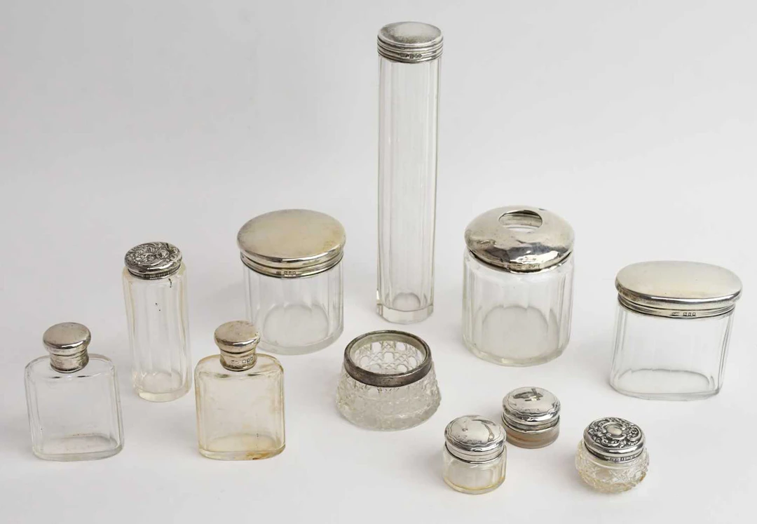 An Edward VII hallmarked silver topped cut glass hat pin jar