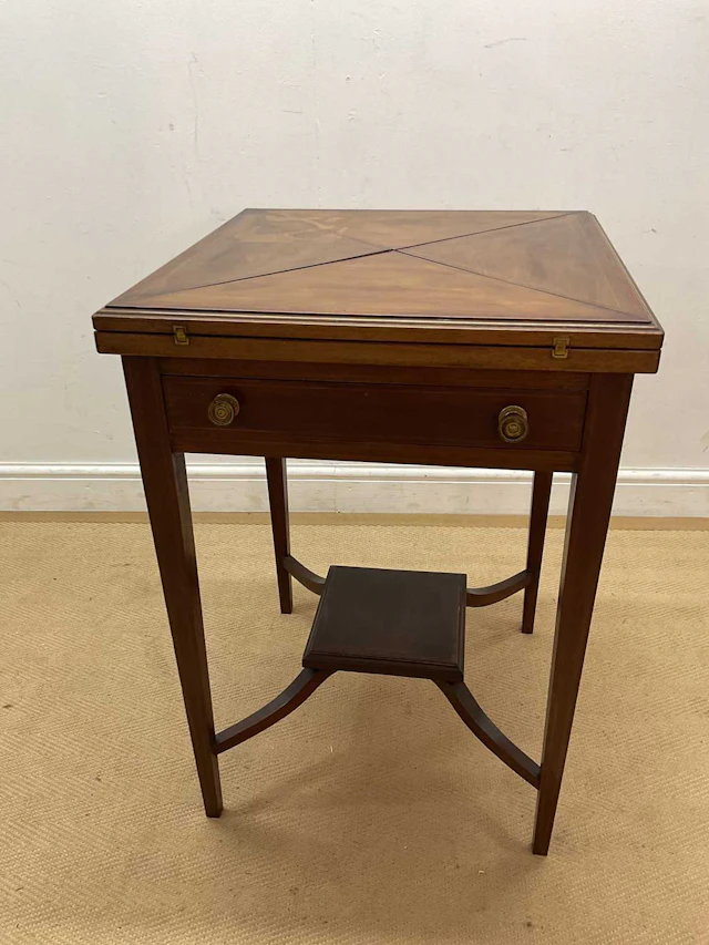 An Edwardian style mahogany inlaid card table