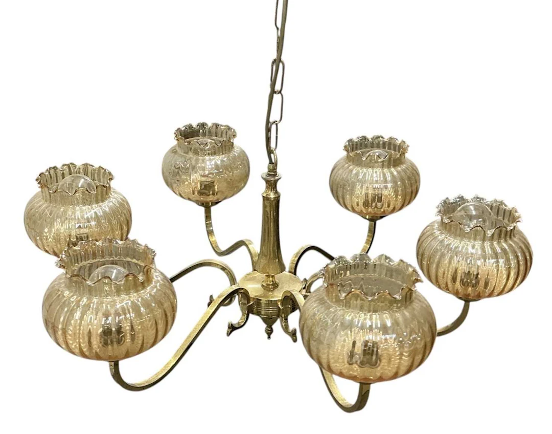 A modern brass six branch chandelier