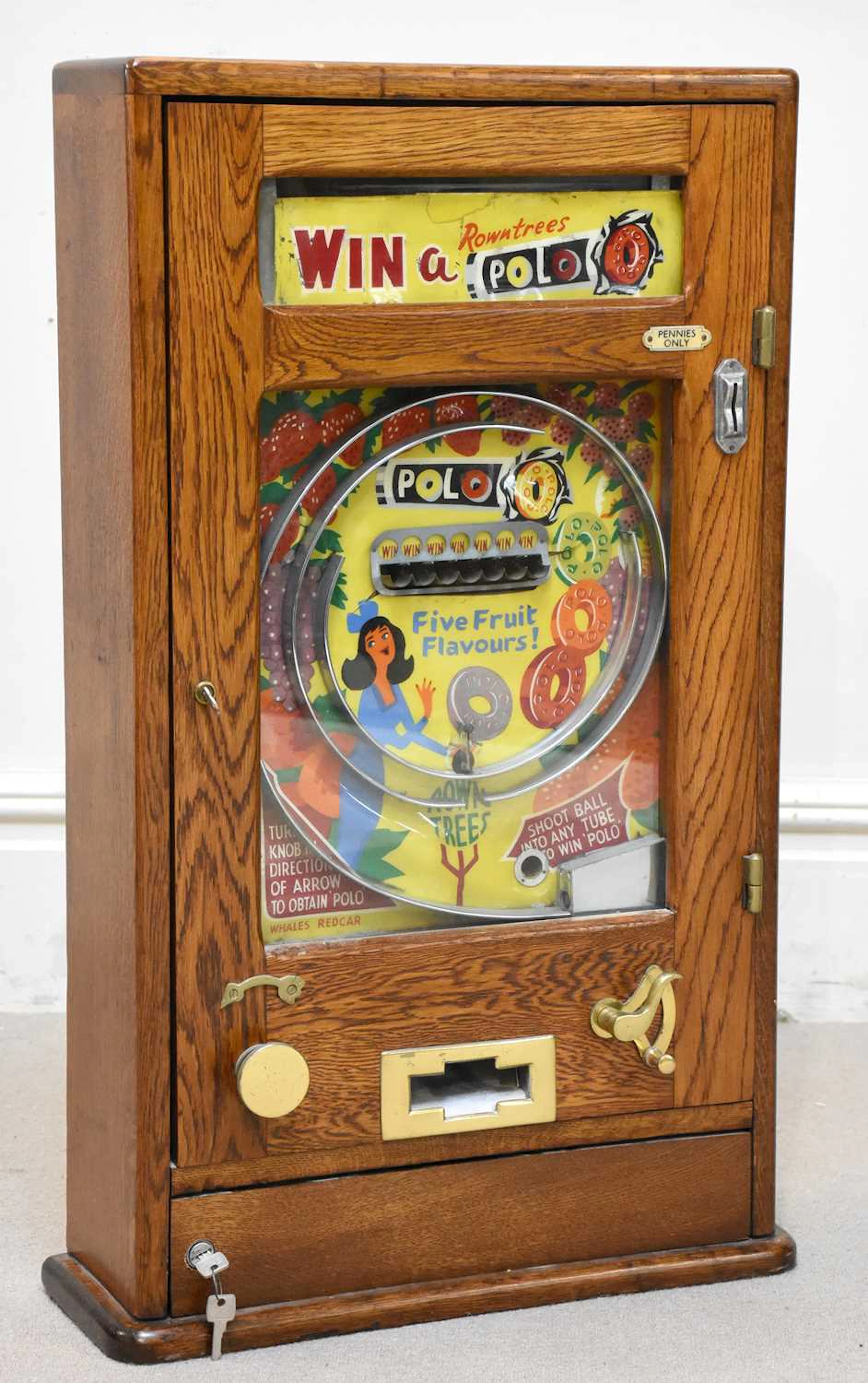 An early 20th century oak cased pin ball machine
