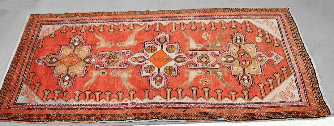 A decorative runner decorated with stylised birds and...