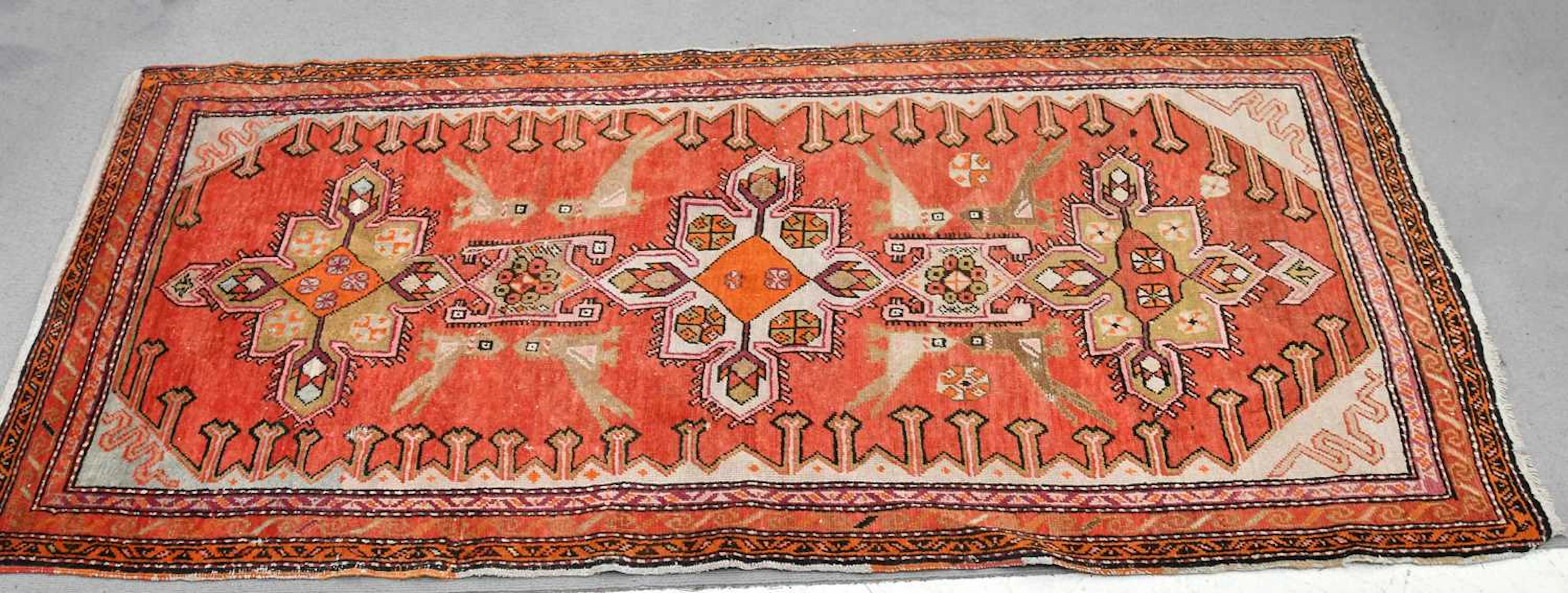 A decorative runner decorated with stylised birds and...