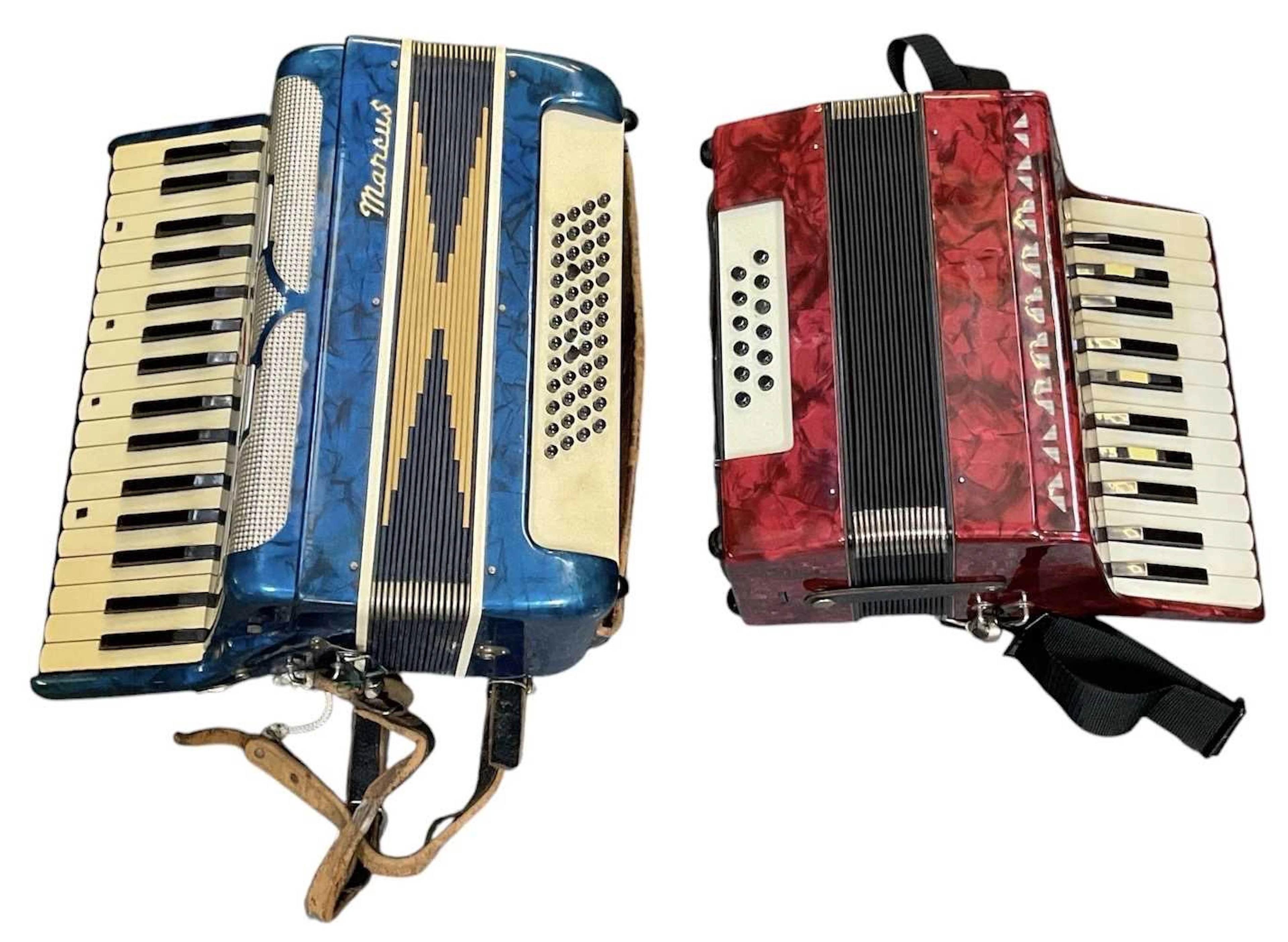 Two Italian piano accordions including a Manus blue accordion